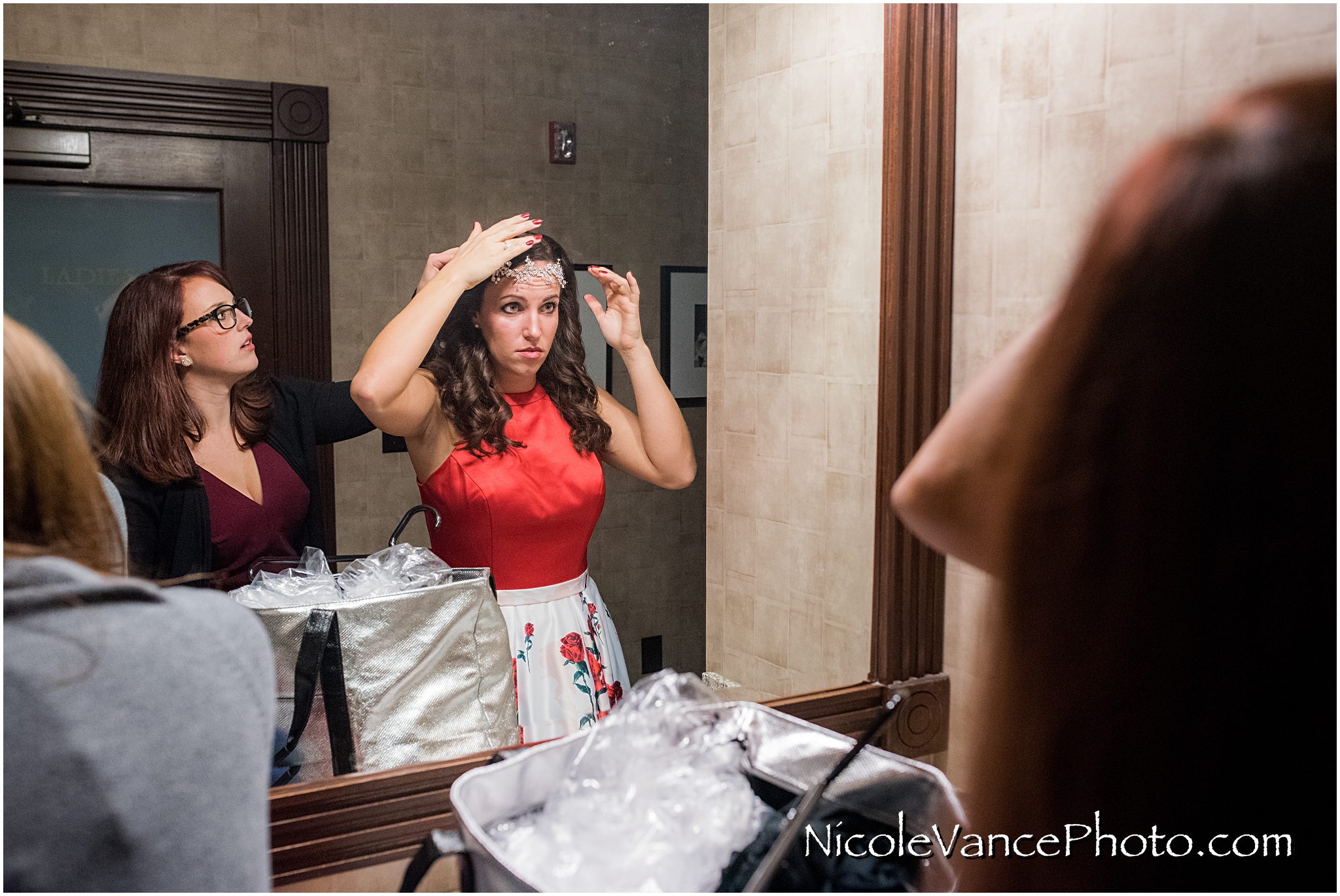 The bride gets last minute touch ups in the bathroom at Bookbinders.