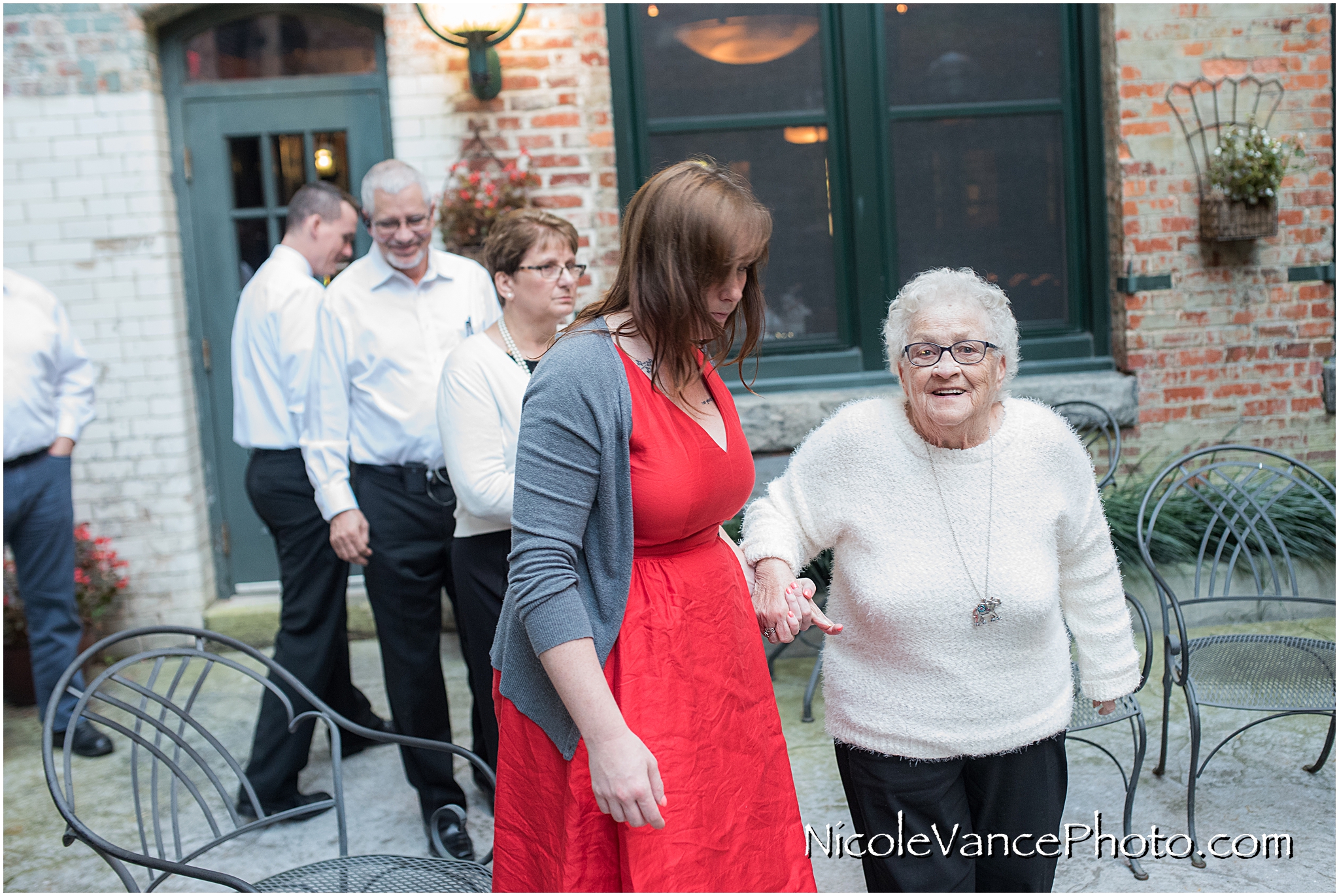 The guests get seated for the ceremony on the back patio Bookbinders.