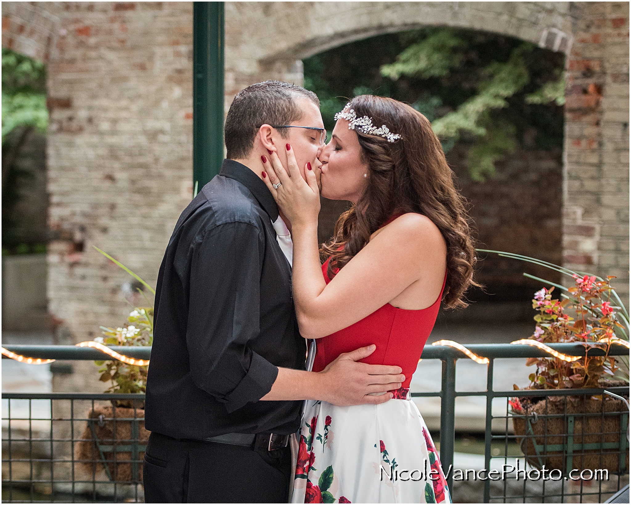 First kiss during their wedding ceremony at Bookbinders on the back patio.