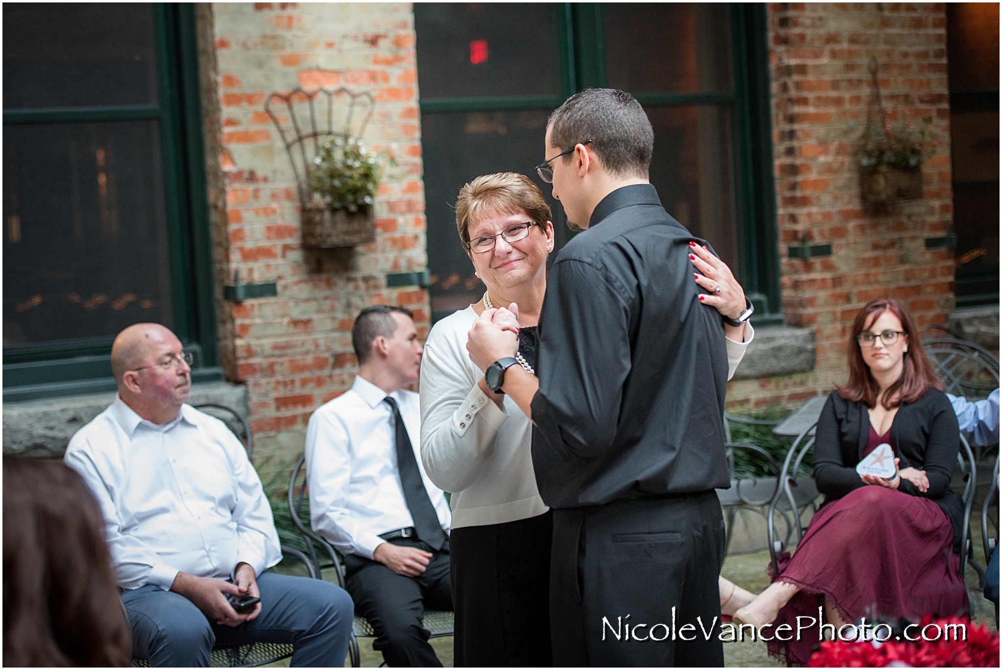 Mother son dance after a wedding ceremony at Bookbinders on the back patio.