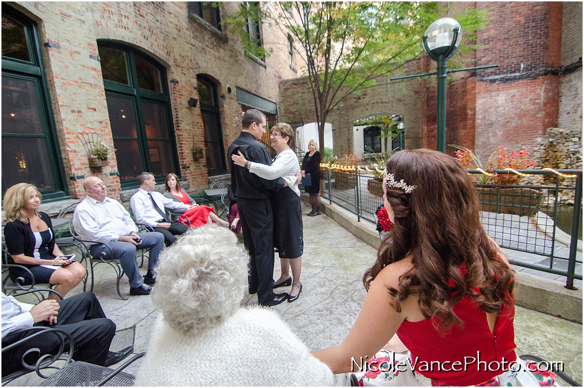 Mother son dance after a wedding ceremony at Bookbinders on the back patio.