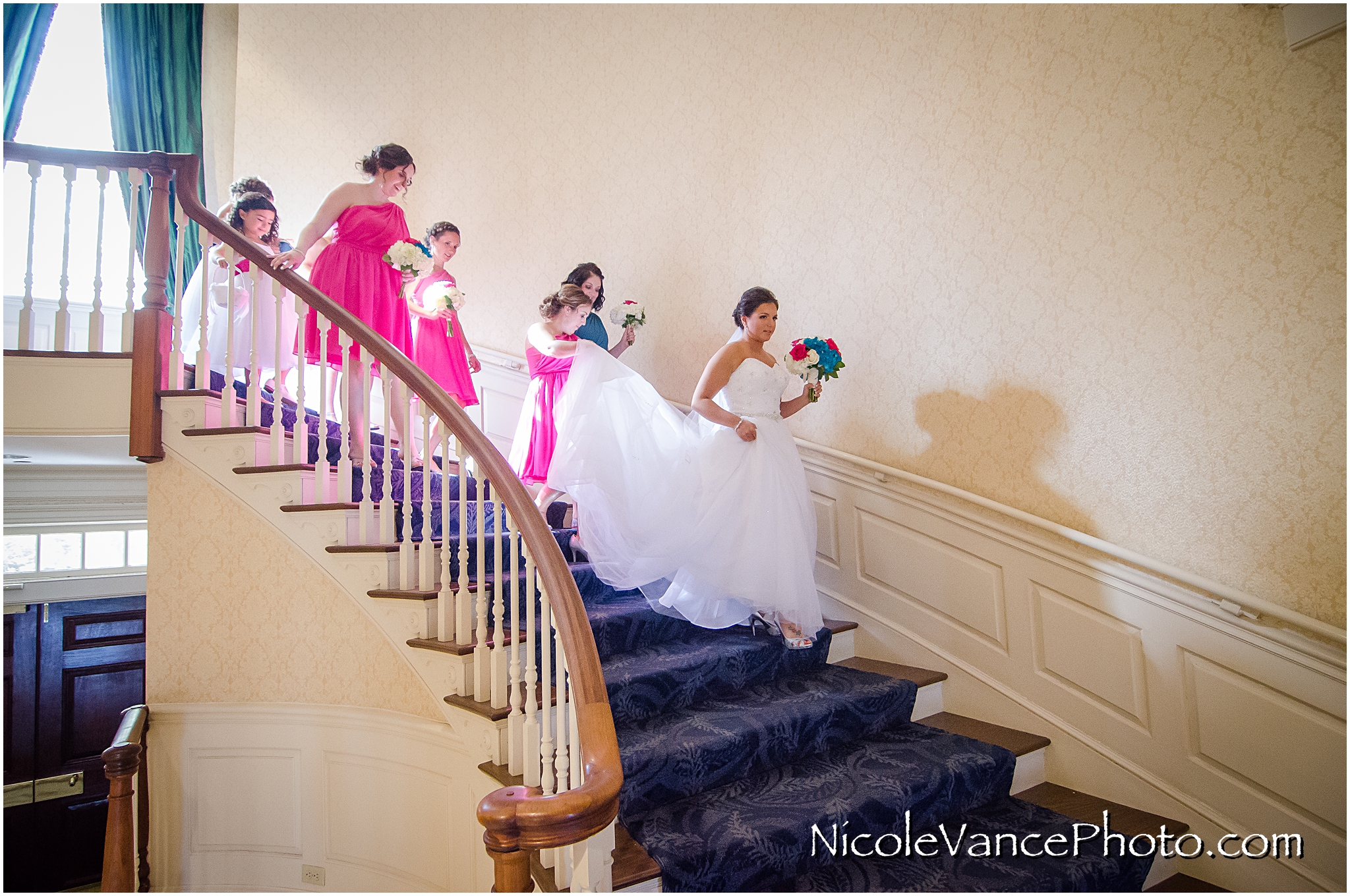 The bridal party makes their way down the stairs at Virginia Crossings.