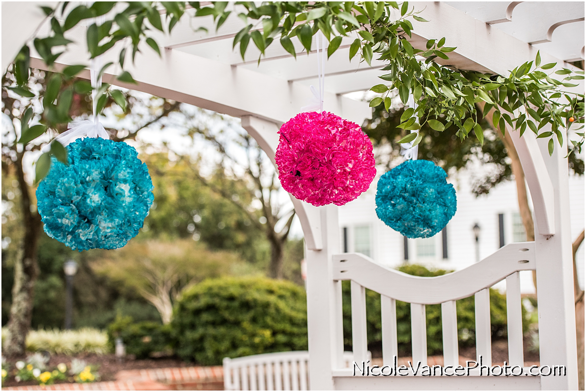 Floral Pomander Balls decorate the pergola at the ceremony site at Virginia Crossings.