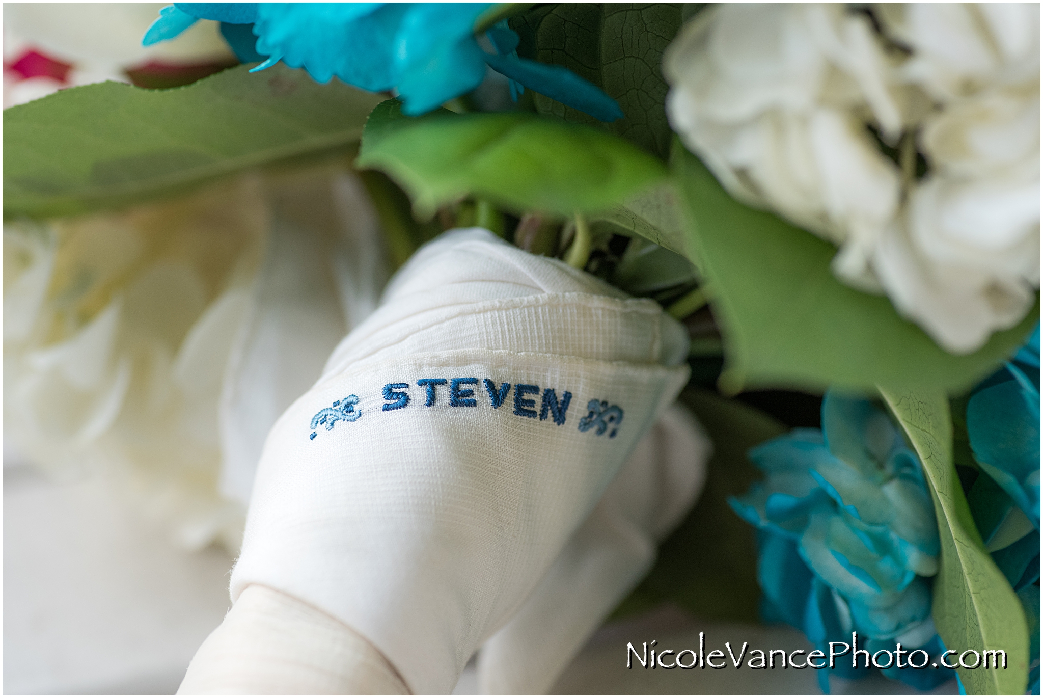 The bride's father's handkerchief decorates the base of her bouquet in his memory.