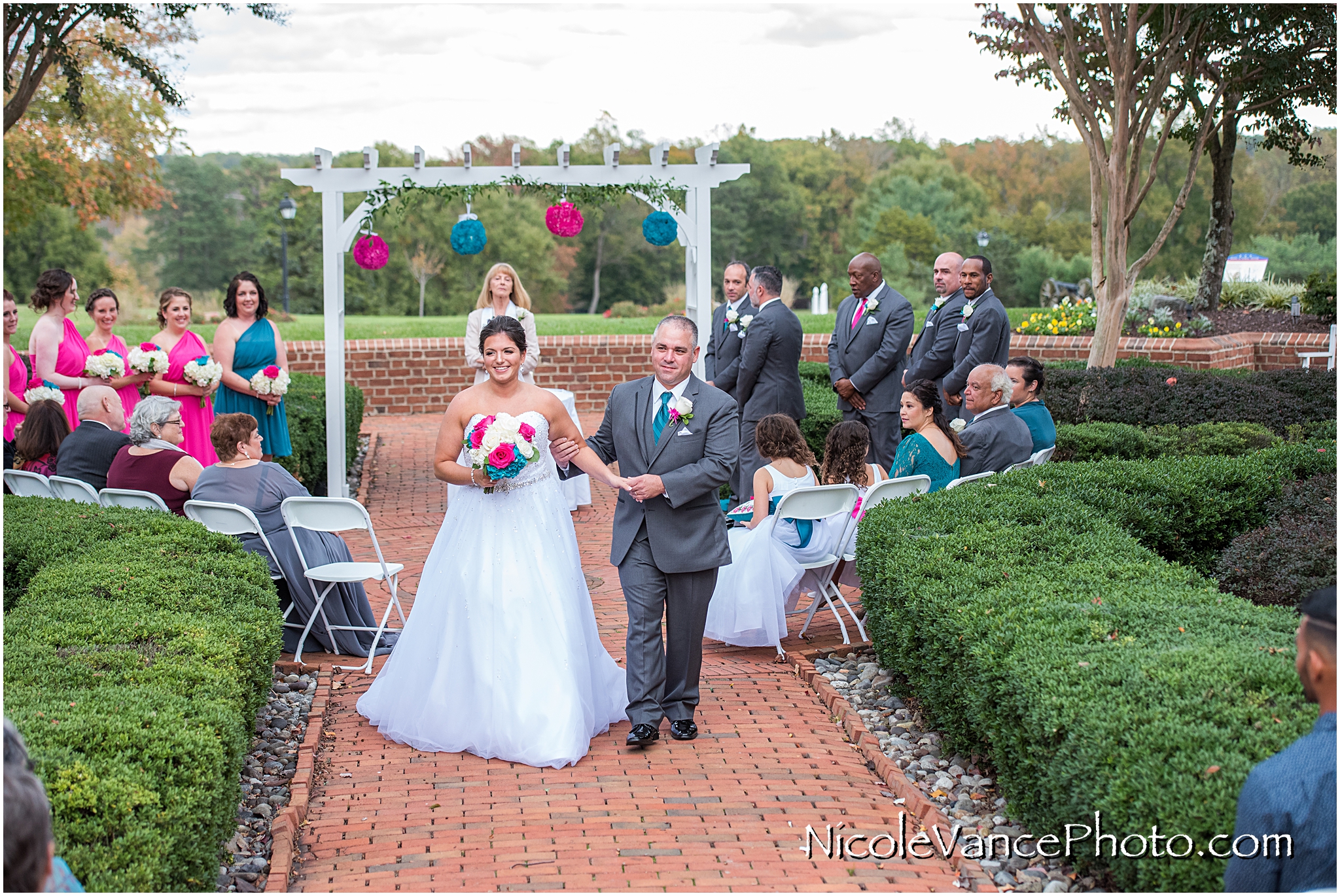 The bride and groom exit the ceremony at Virginia Crossings.