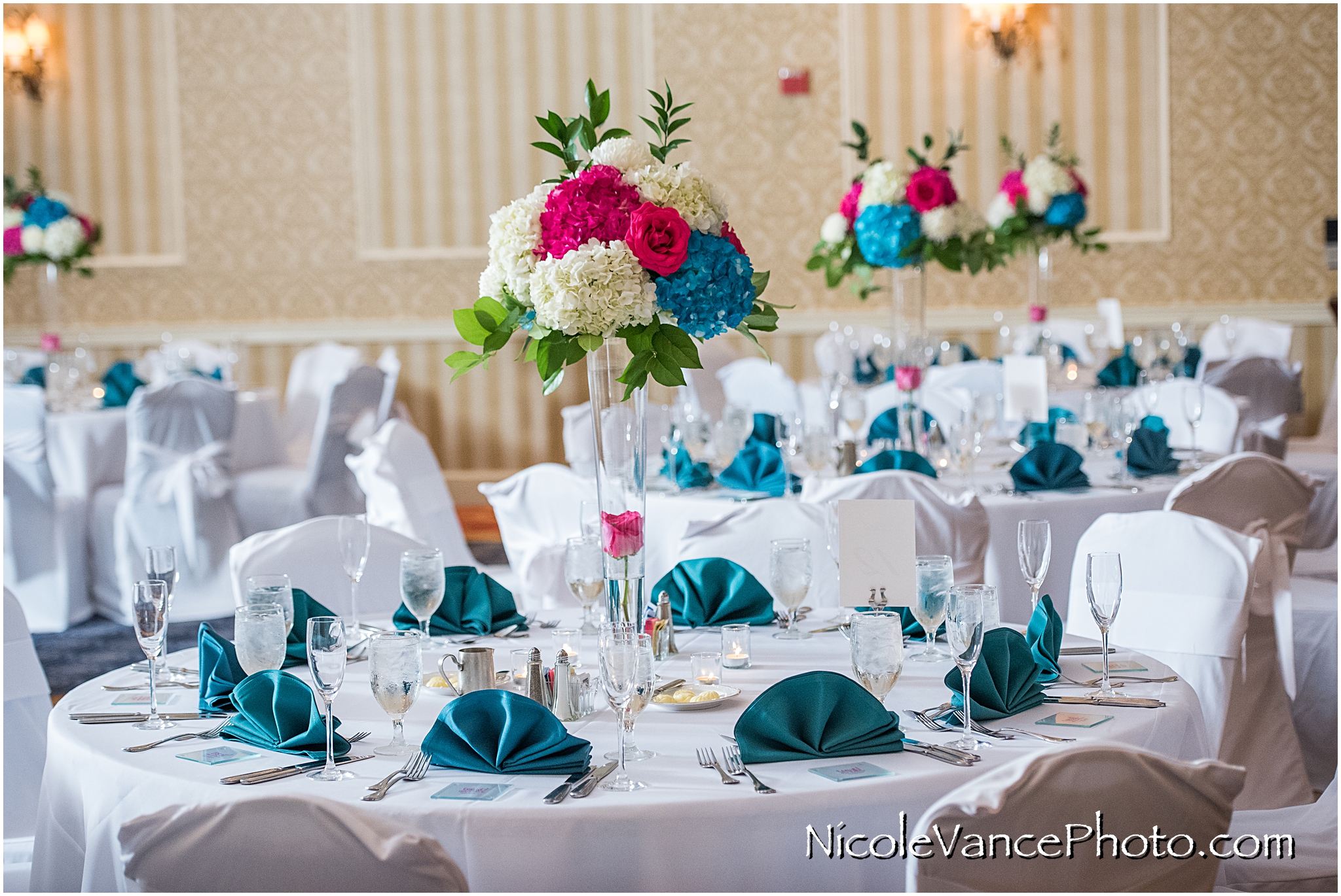Floral arrangements provided by Flowers by Zoie adorn the tables at the reception at Virginia Crossings.