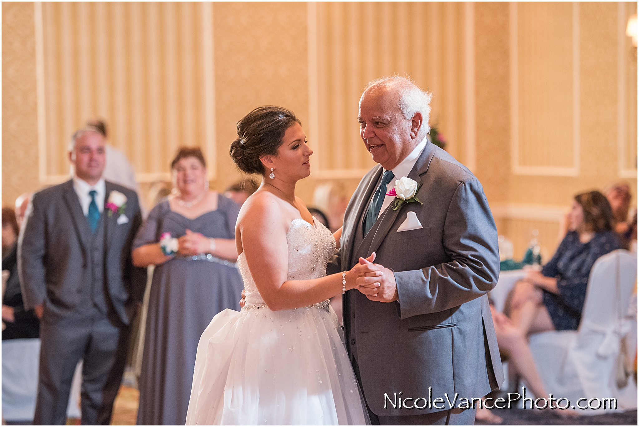 The bride dances with her new father in law in the ballroom at Virginia Crossings.