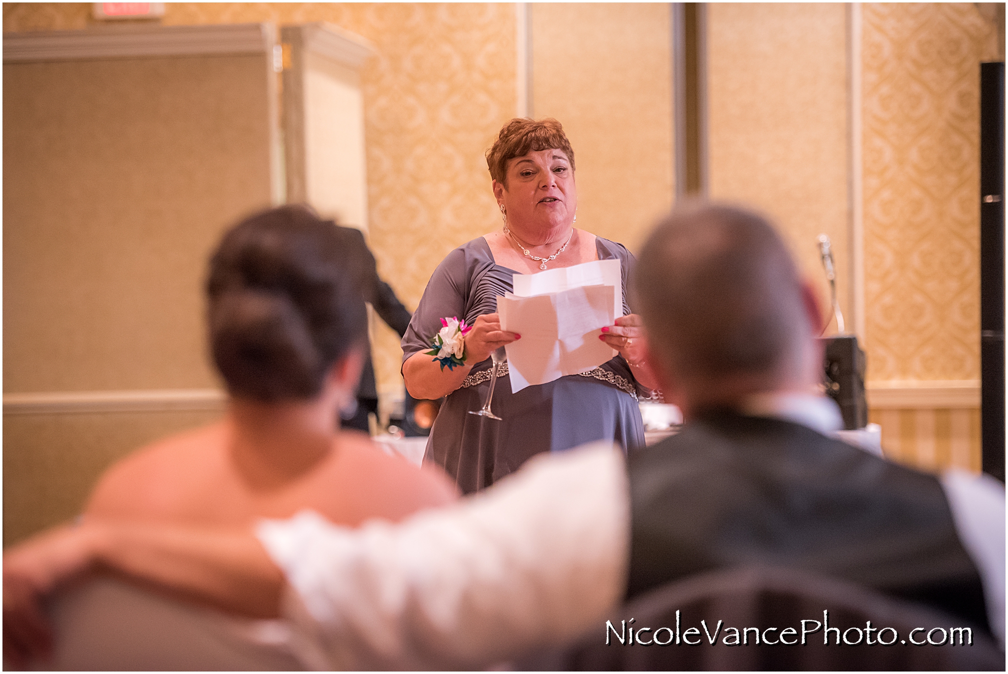 The bride's mom makes a toast at the reception at the Virginia Crossings.