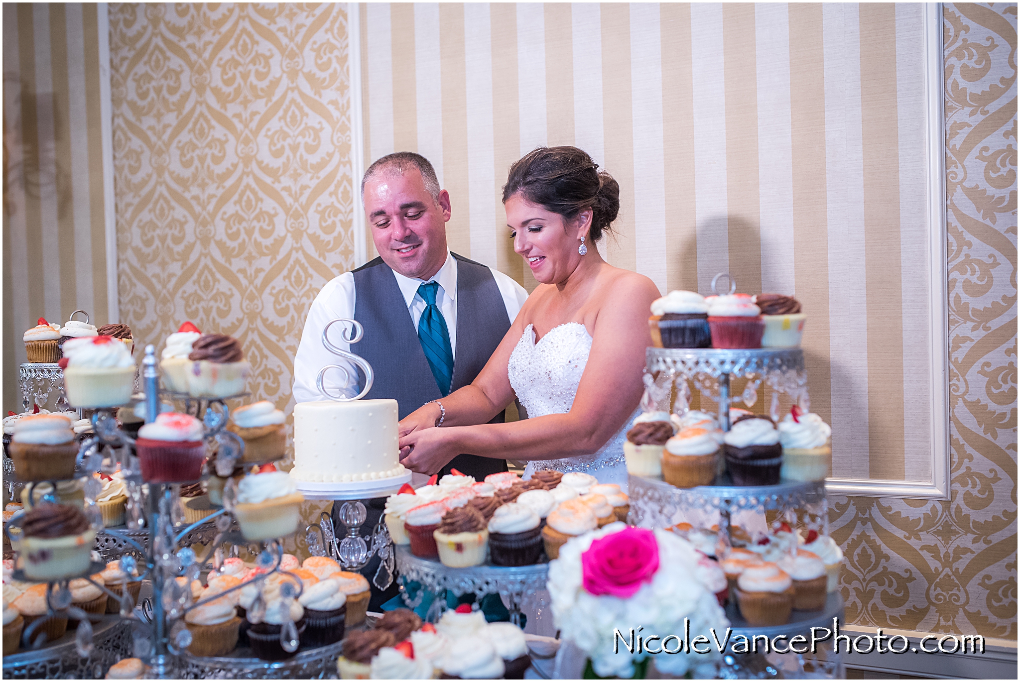 The bride and groom cut their wedding cake provided by Pearls at Virginia Crossings.