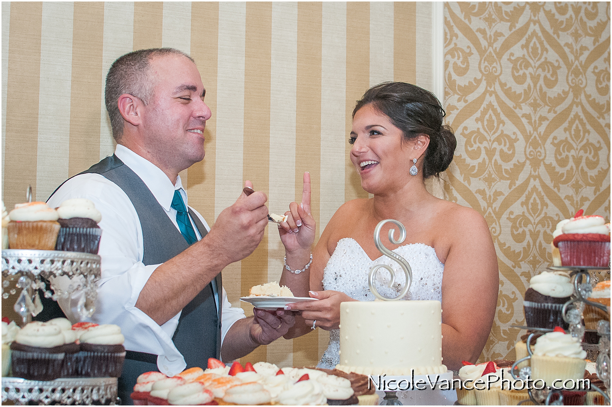 The bride and groom cut their wedding cake provided by Pearls at Virginia Crossings.