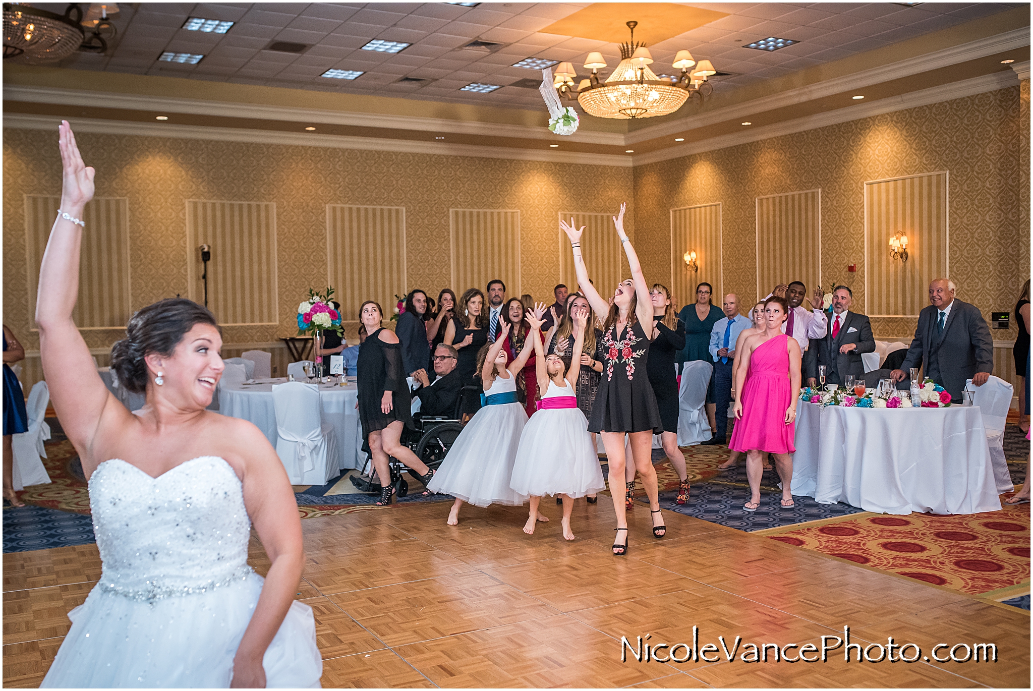 The bride tosses the bouquet at her reception at Virginia Crossings.