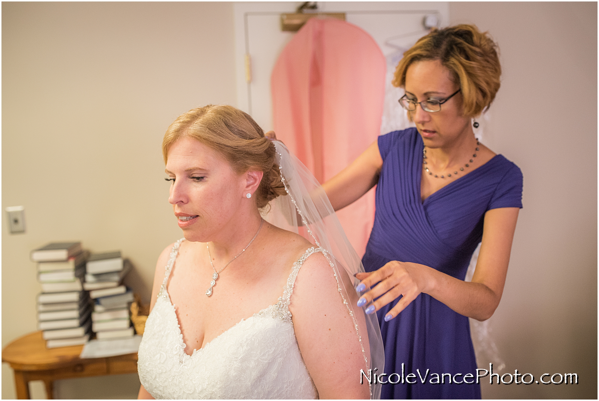 The bride's veil is the final touch for her perfect look.