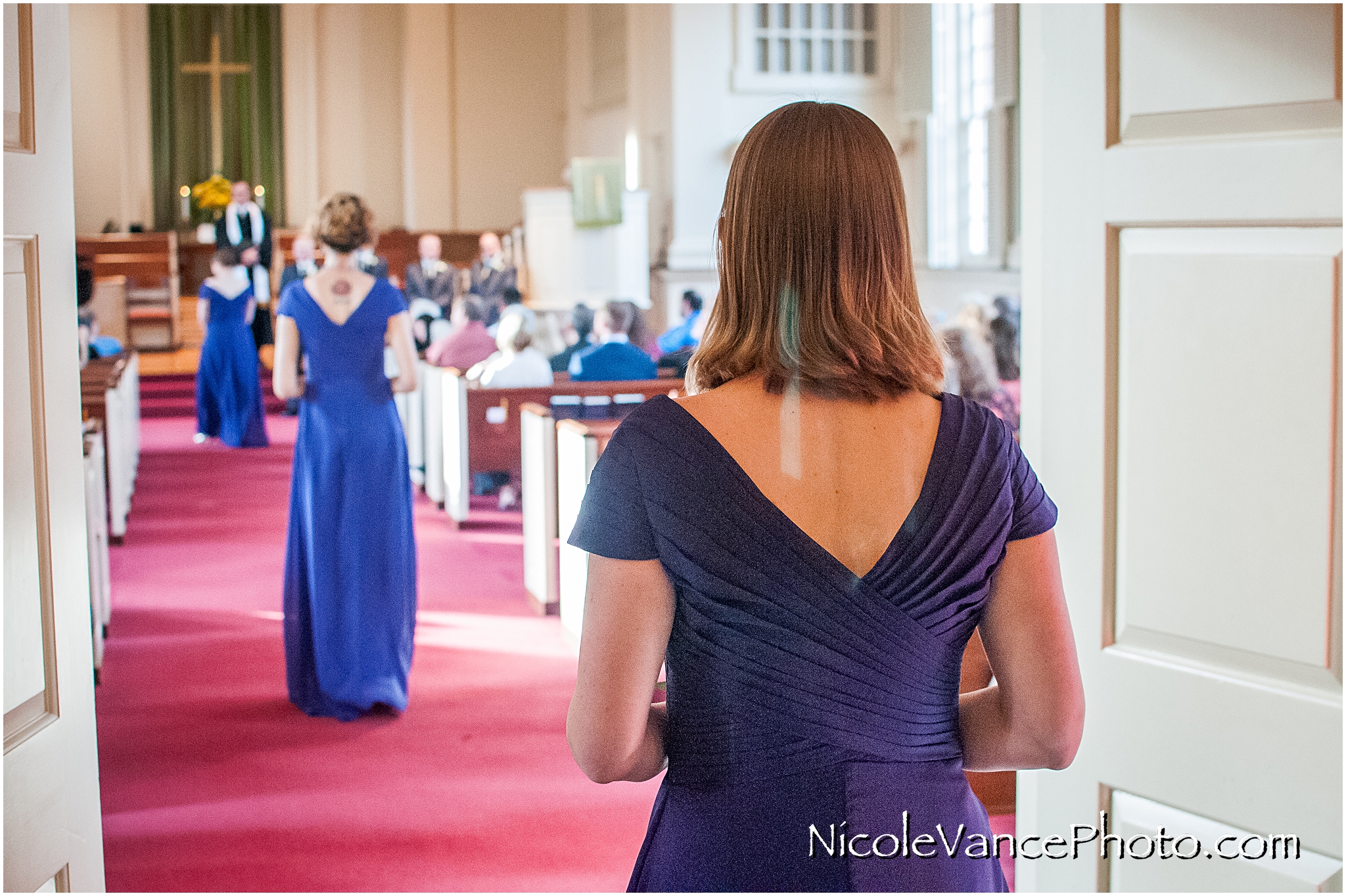 The bridesmaids proceed down the aisle.