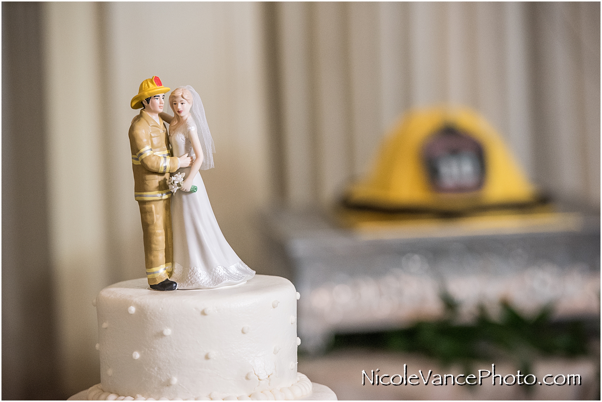 This classic wedding cake is topped with a very special cake topper featuring a firefighter. 