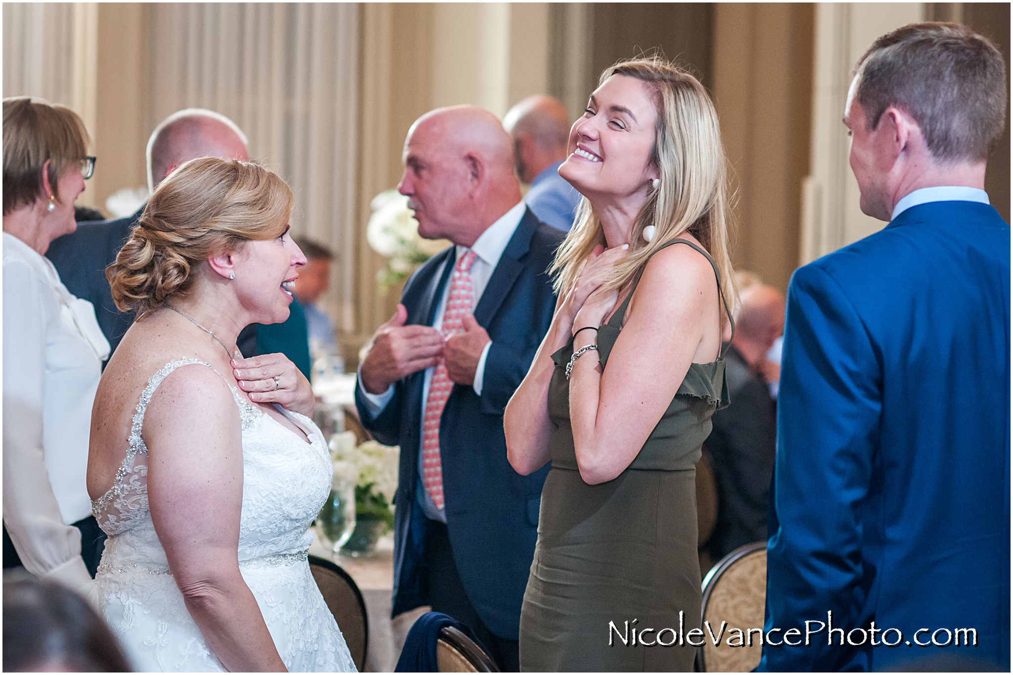 The bride greets her guests during her reception at the Hotel John Marshall.