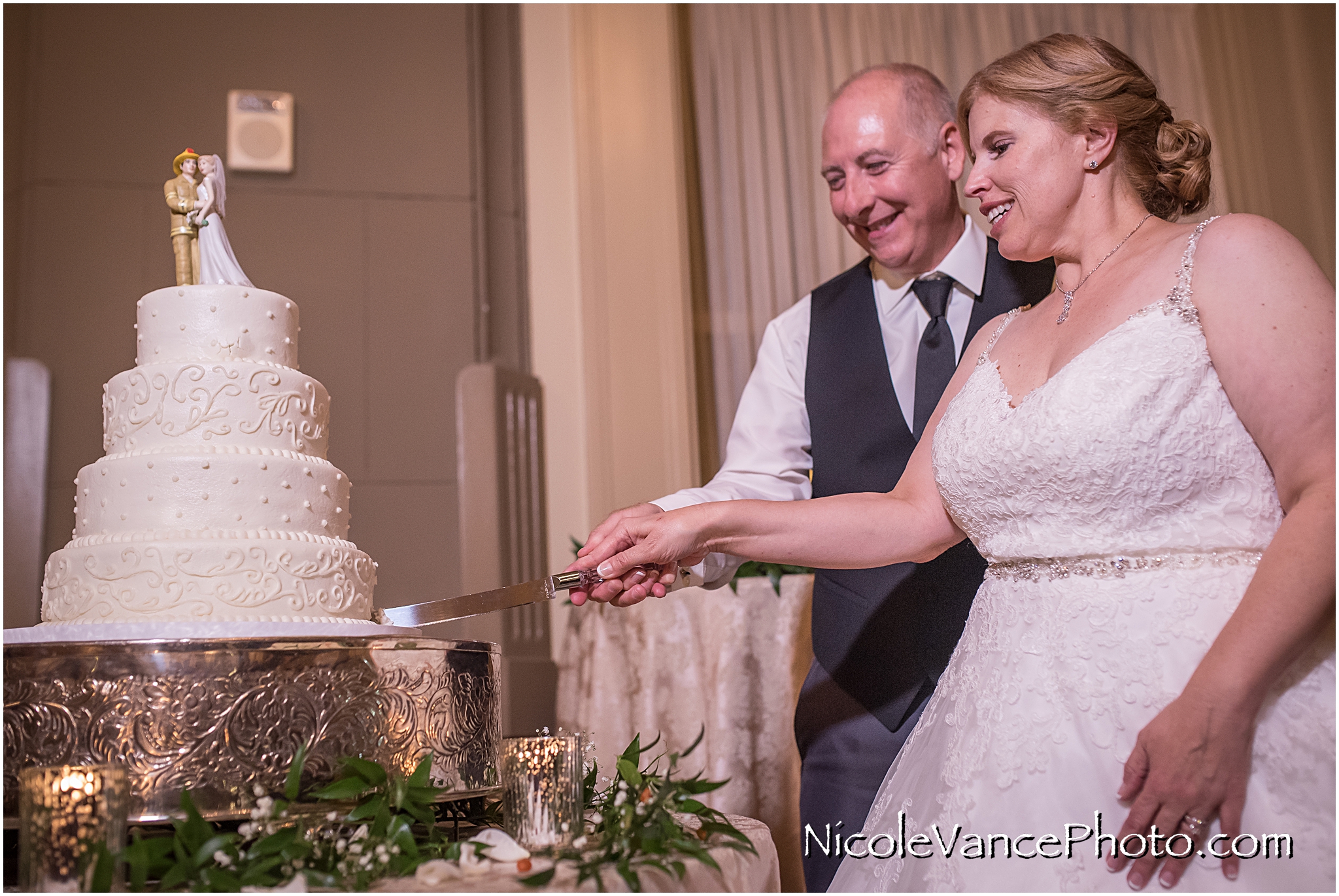 The couple cut their wedding cake prepared by Sugar Cain Bakery.