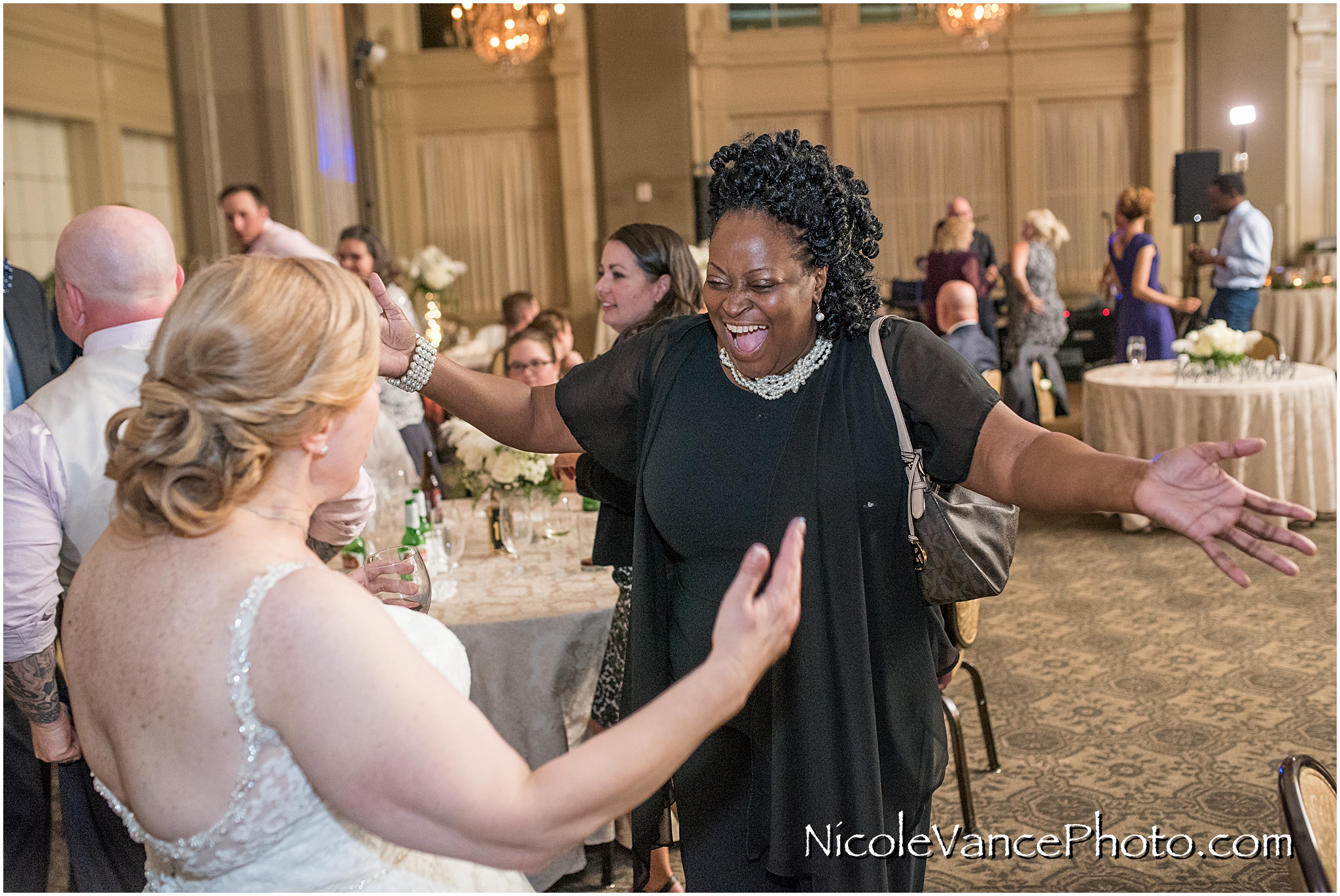 The bride greets her guests at her reception at the John Marshall Hotel.