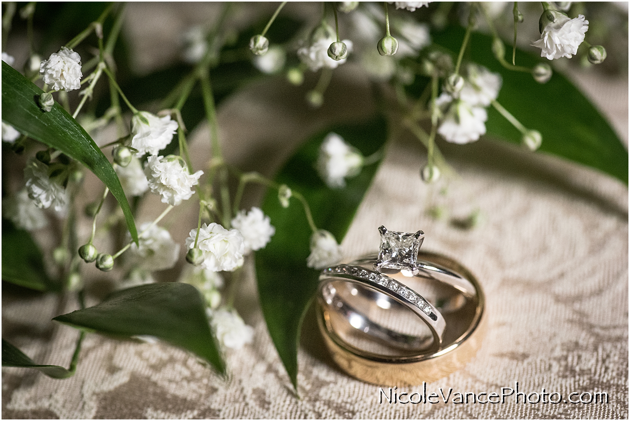 Baby's breath and greenery accent this beautiful bridal jewelry.