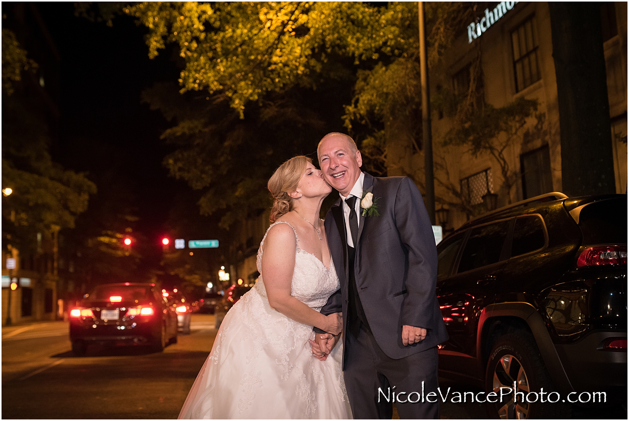 The happy couple outside on the street at the John Marshall Hotel.