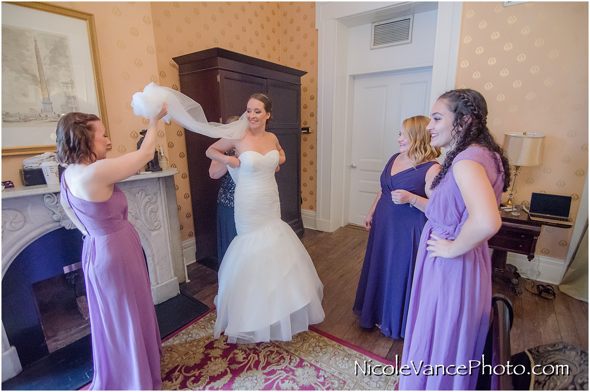Her mom helps her get into her dress in the Bridal Suite at the Linden Row Inn.