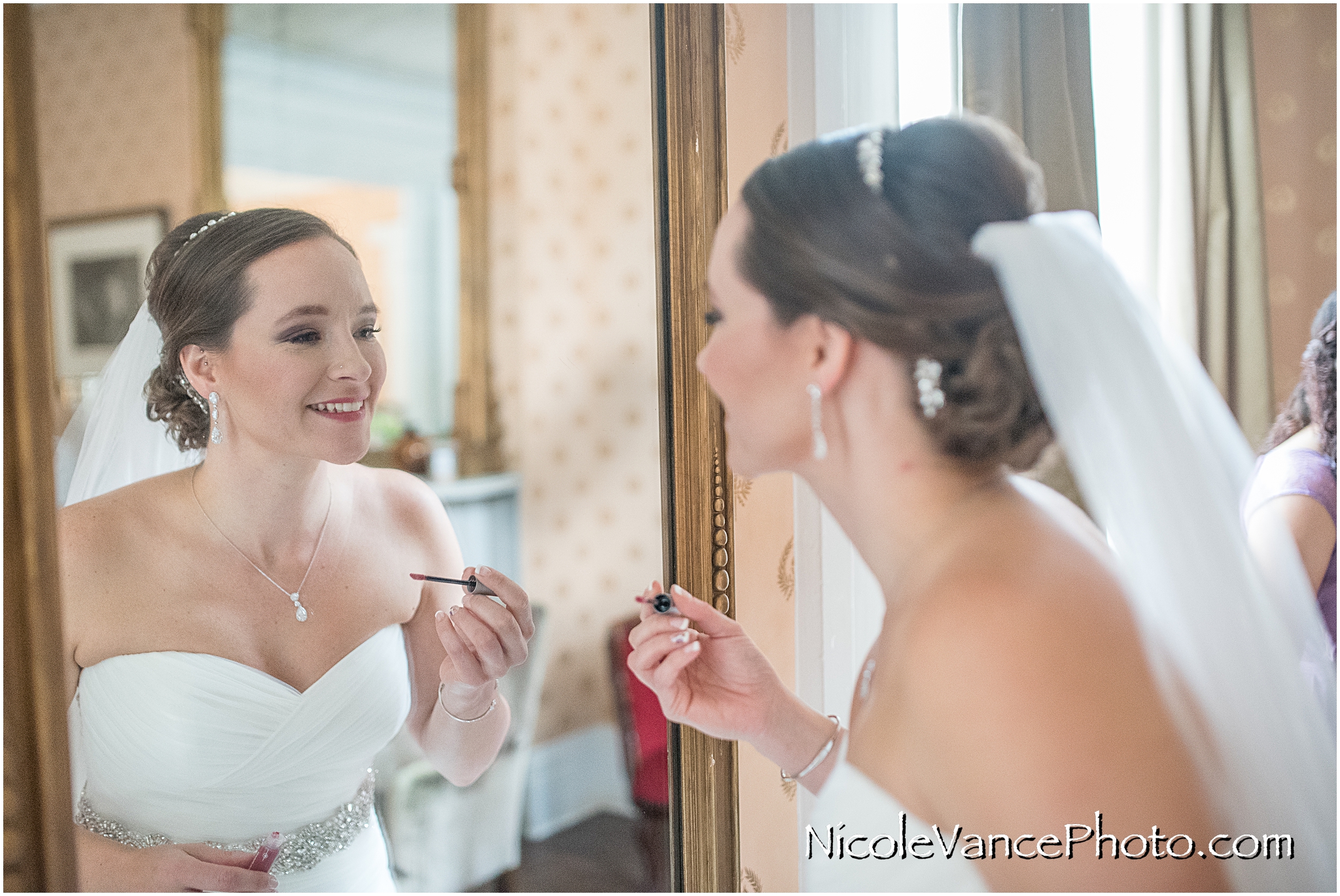 Last minute lipstick touch up before her first look with her husband-to-be.