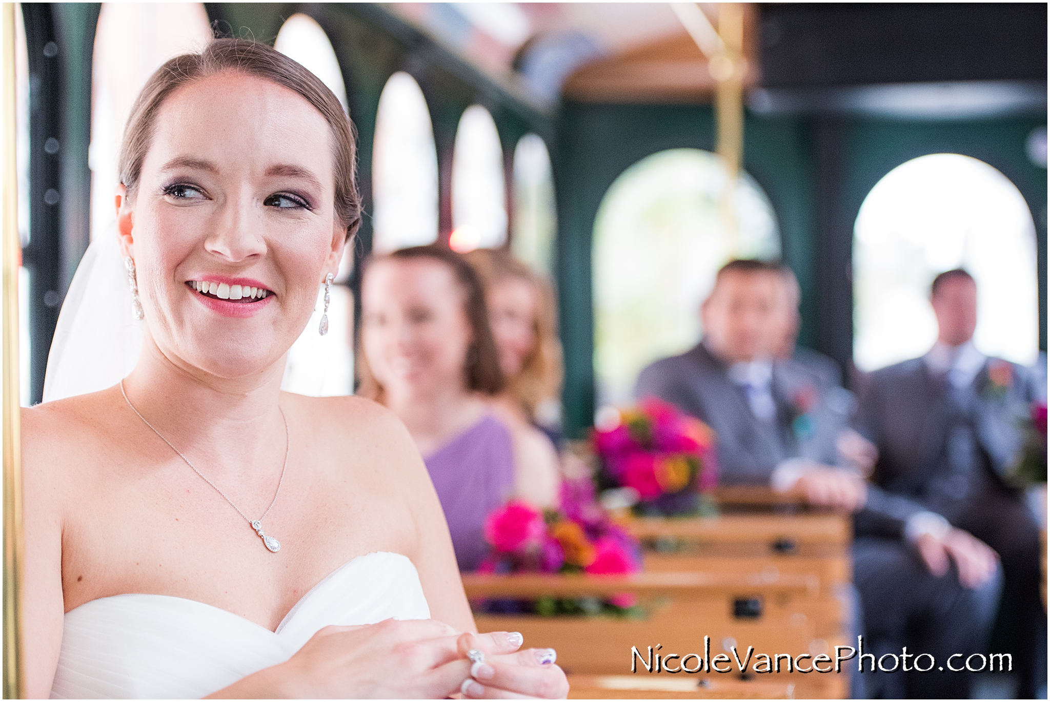 The bride and groom travel to their wedding aboard a trolley.