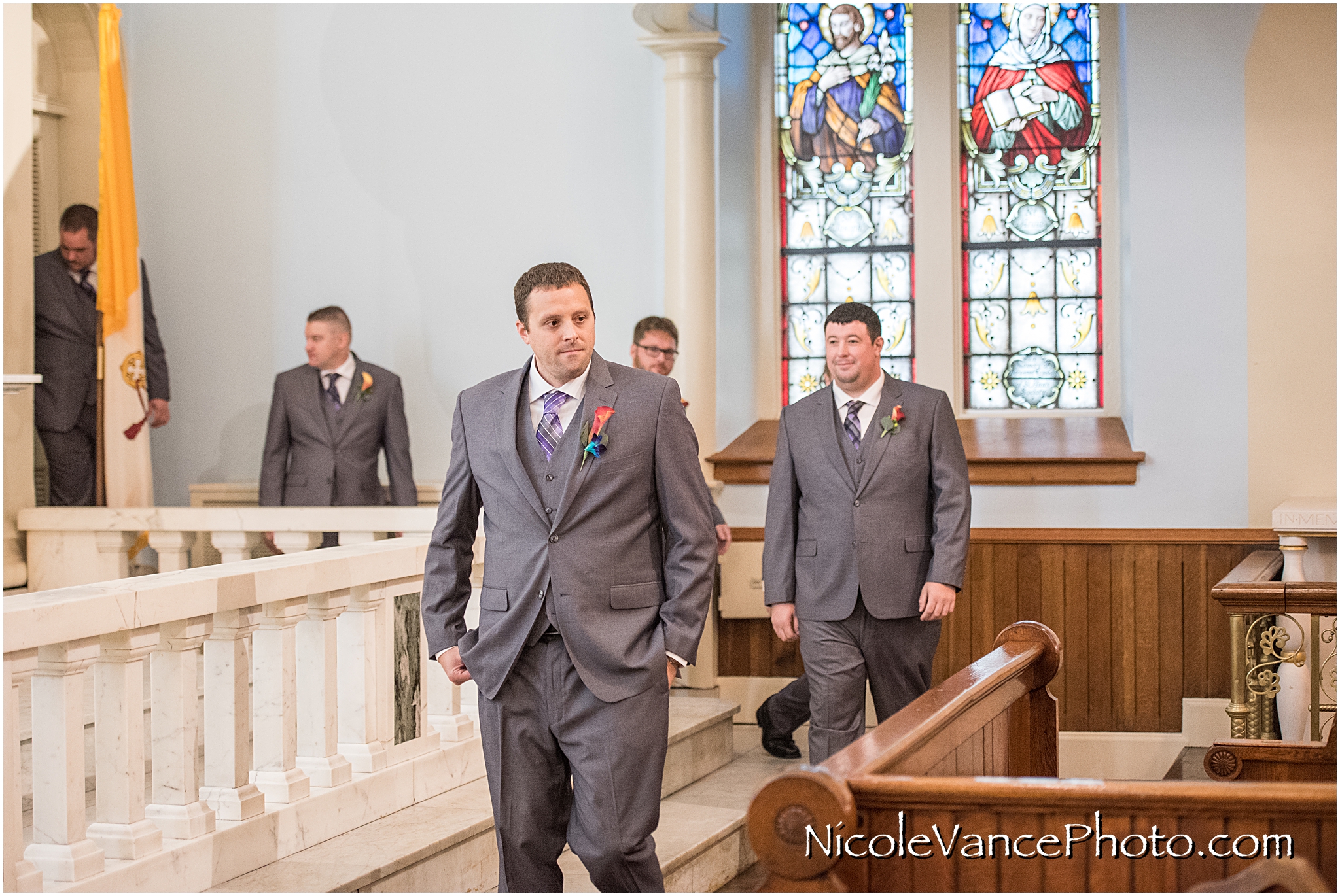 The groom makes an entrance at St Peter's Catholic Church, in Richmond VA.