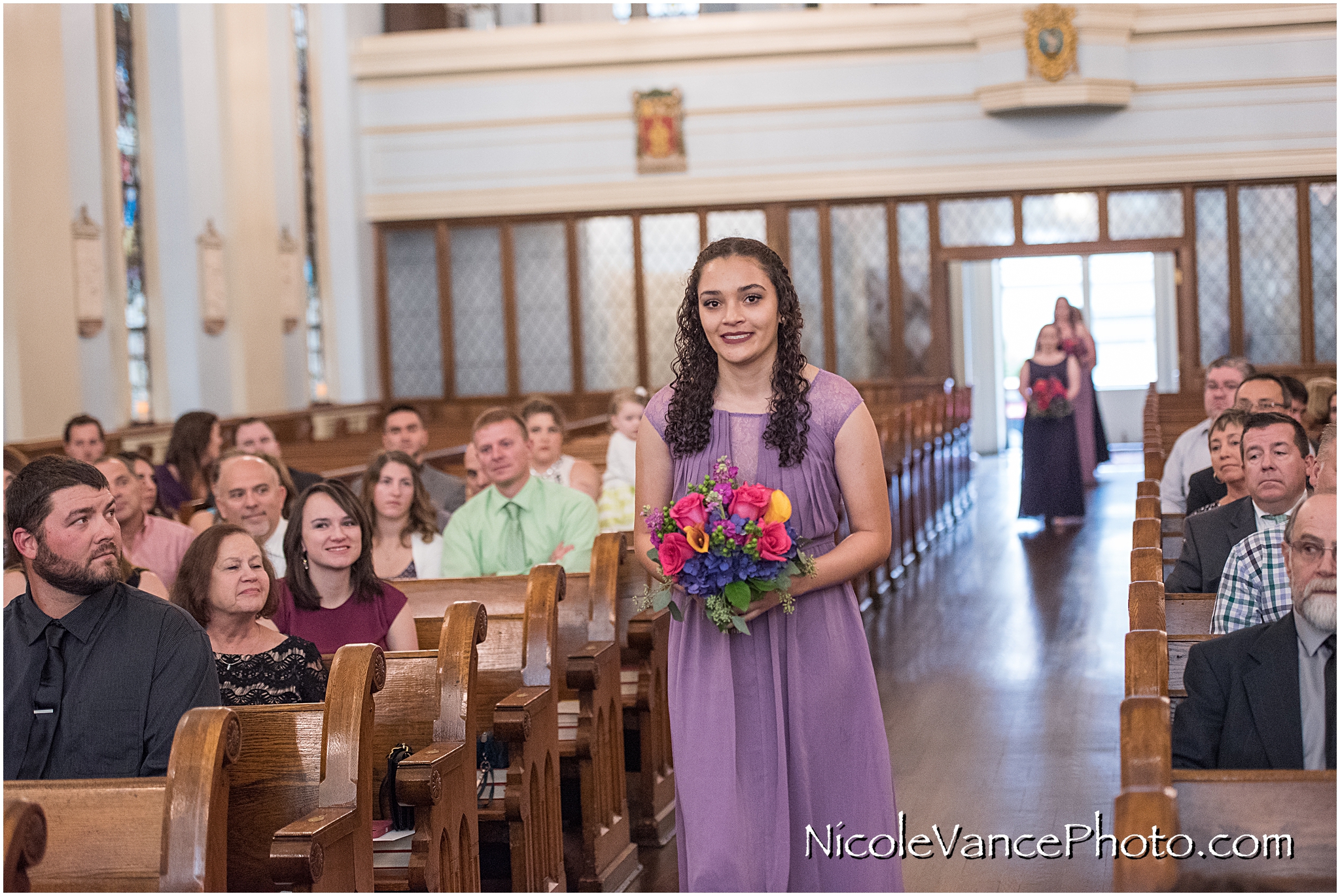 The bridesmaids make an entrance at St Peter's Catholic Church, in Richmond VA.