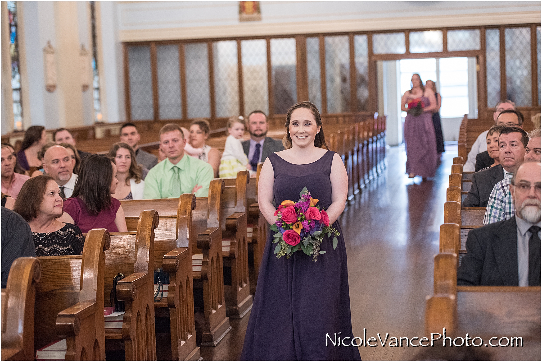 The bridesmaids make an entrance at St Peter's Catholic Church, in Richmond VA.