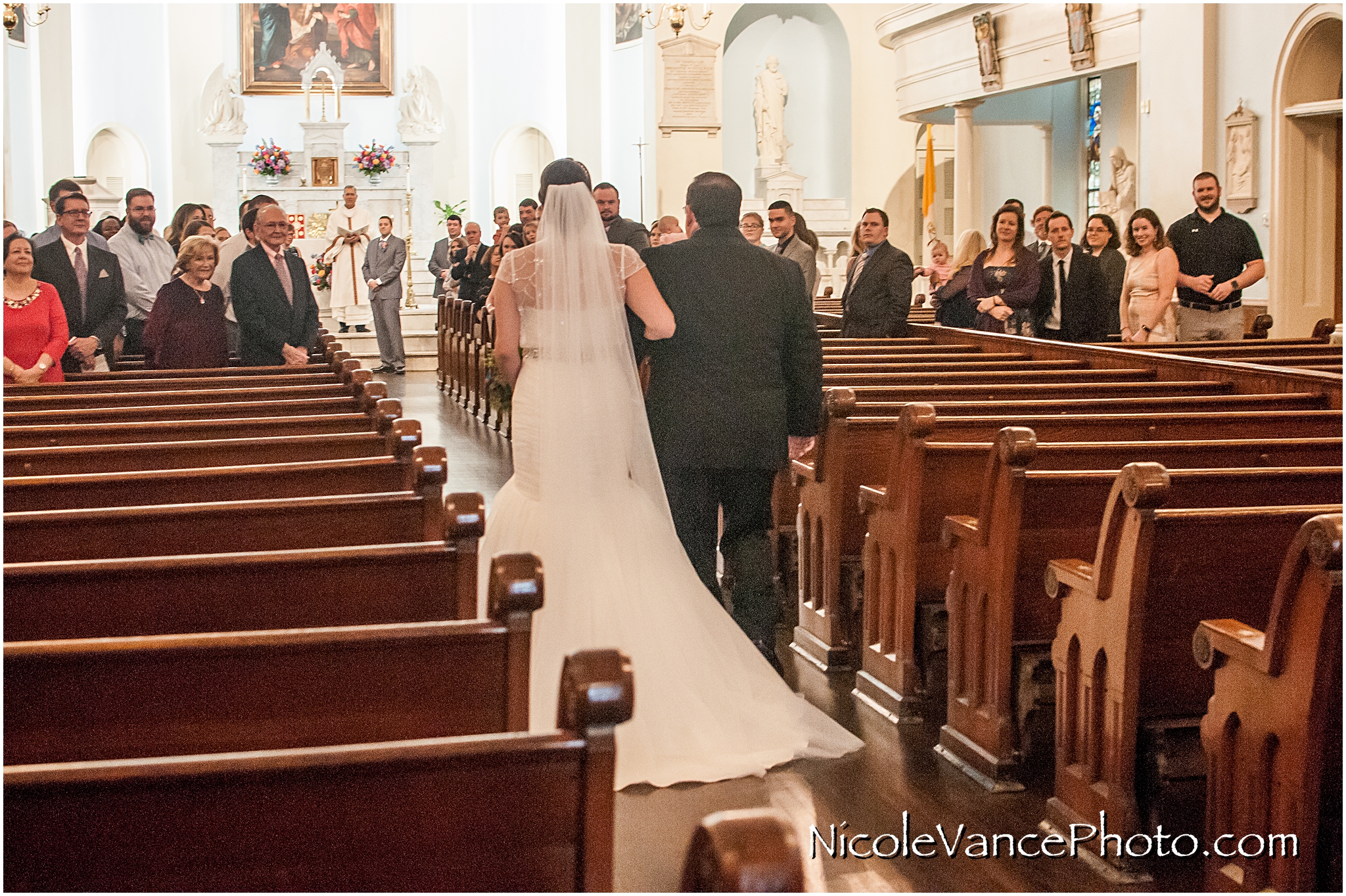 The groom sees his bride enter at St Peter's Catholic Church, in Richmond VA.