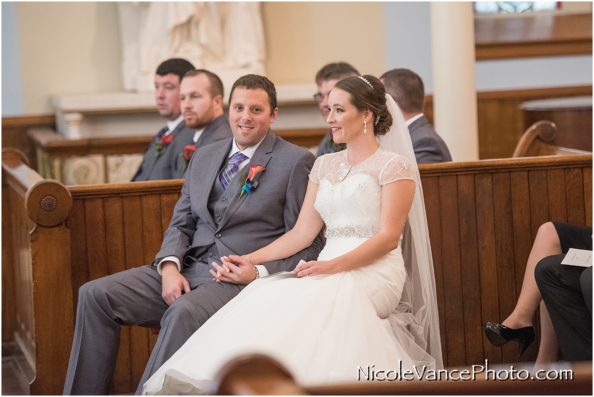 The bride and groom enjoy their wedding ceremony at St Peter's Catholic Church in Richmond, VA.