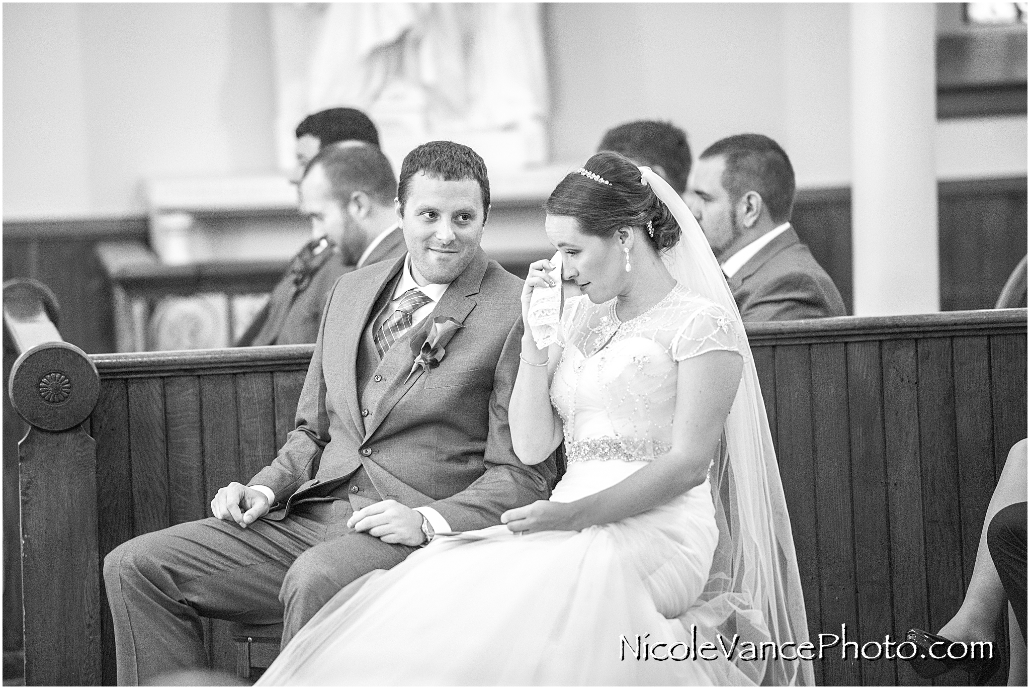 The bride and groom enjoy their wedding ceremony at St Peter's Catholic Church in Richmond, VA.