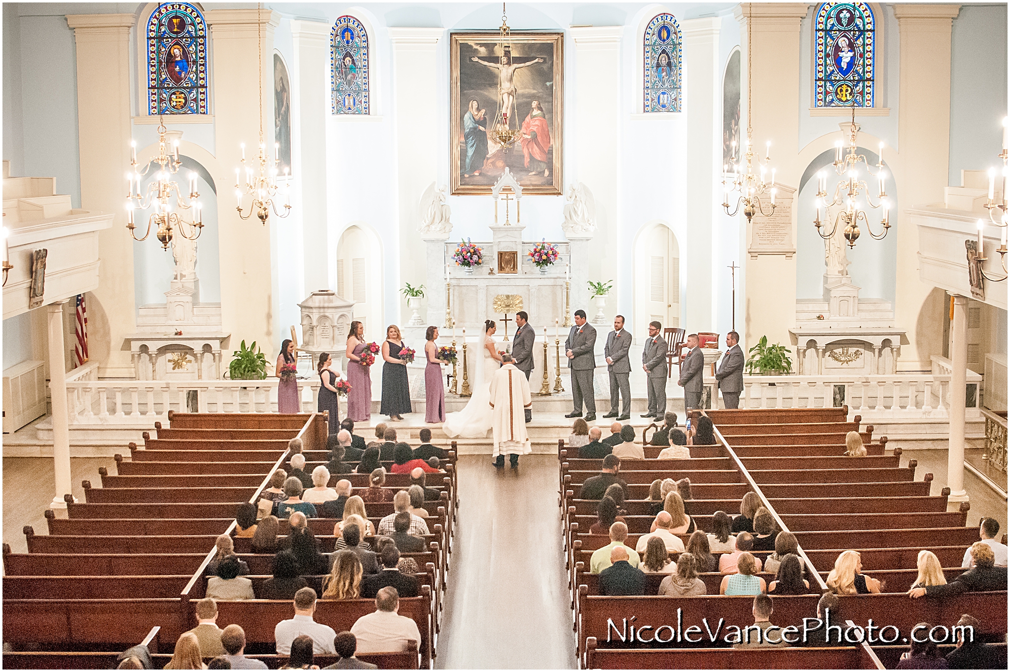 The bride and groom enjoy their wedding ceremony at St Peter's Catholic Church in Richmond, VA.