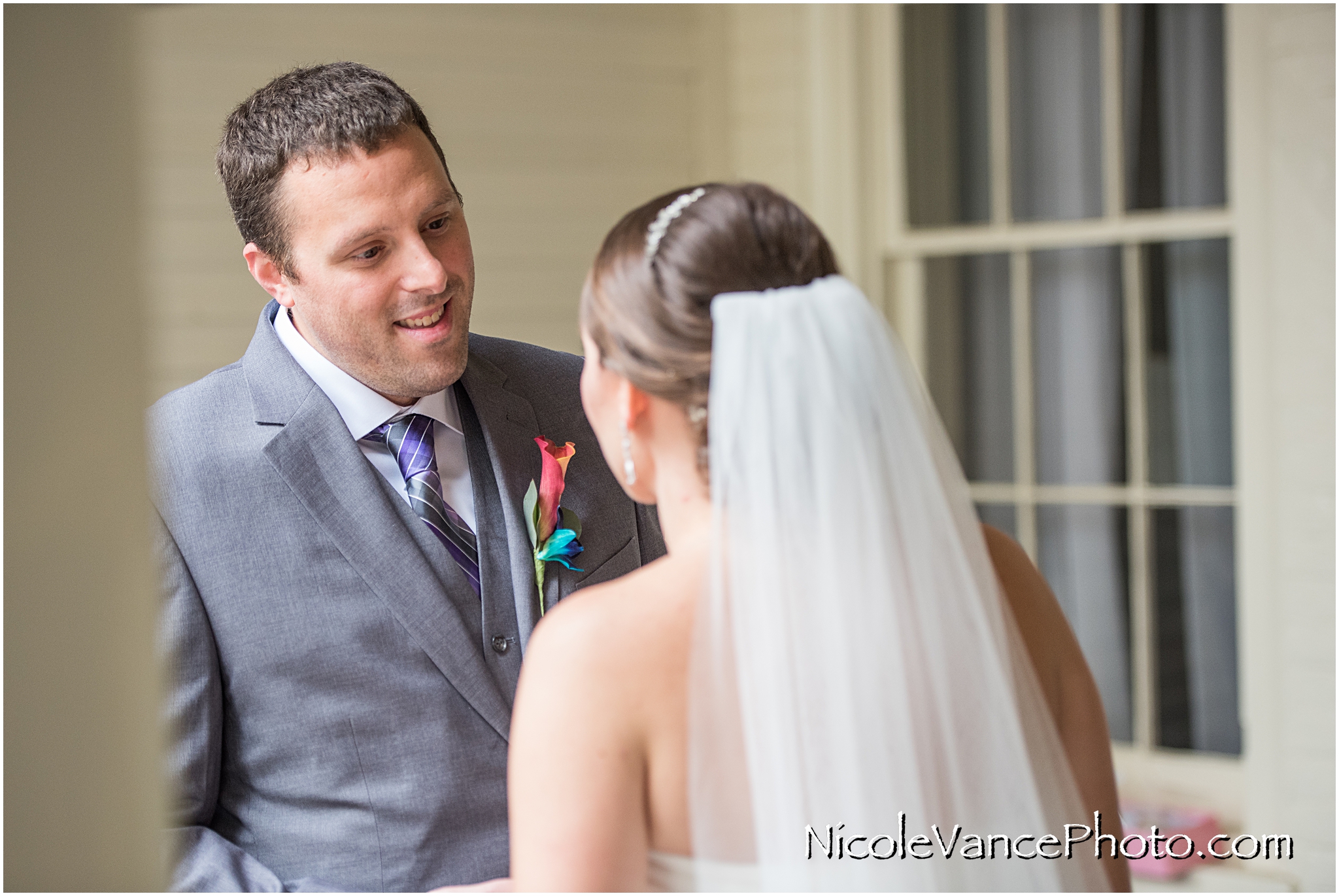 The bride and groom have a private first look on the balcony of the Linden Row Inn.