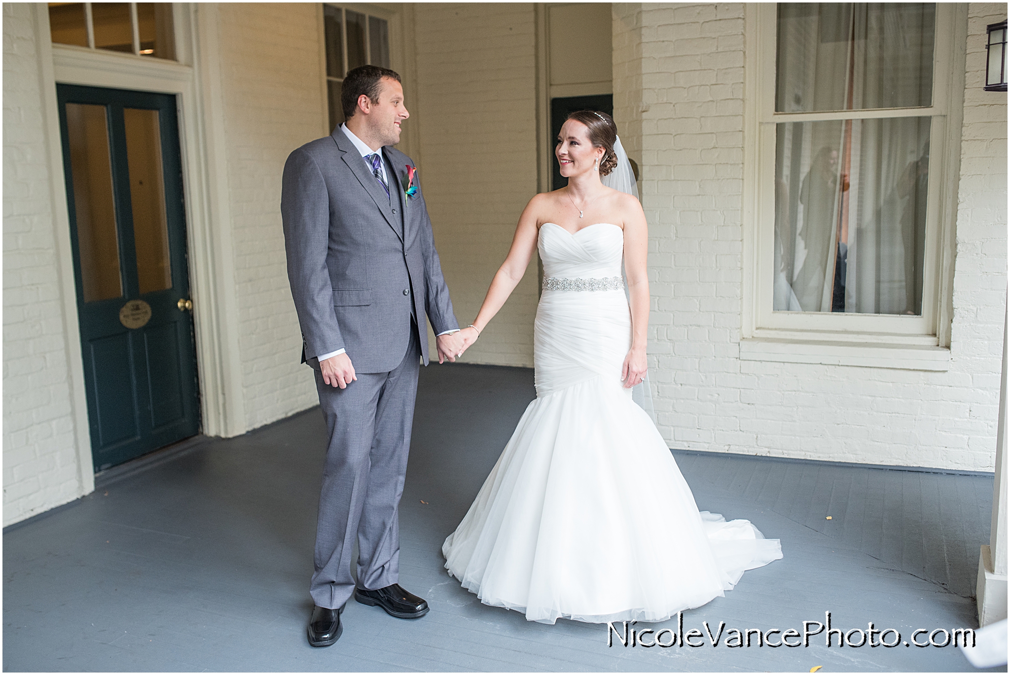 The bride and groom have a private first look on the balcony of the Linden Row Inn.