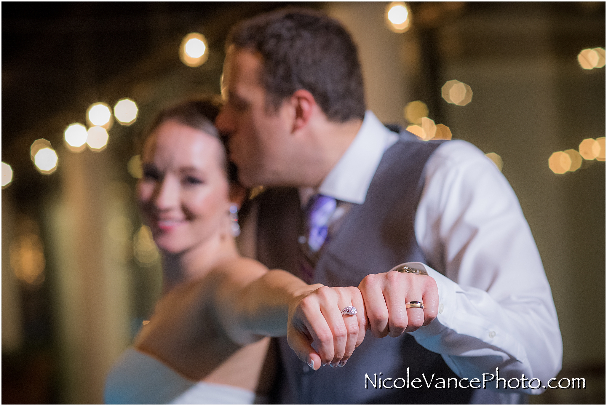 The bride and groom show off their new wedding rings on the patio together at the Brownstone in Richmond, VA.