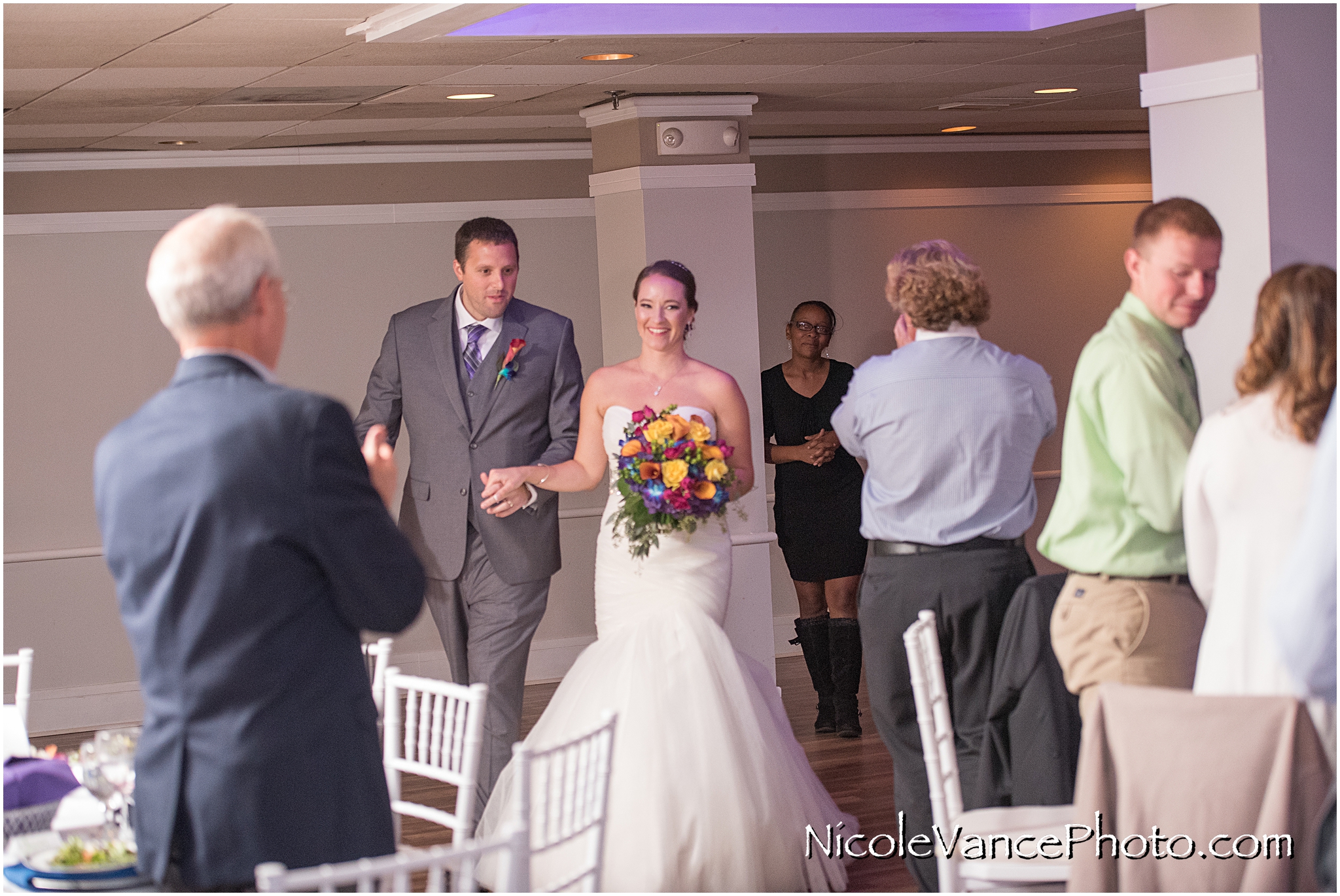 The bride and groom makes an entrance at their wedding reception at The Brownstone.