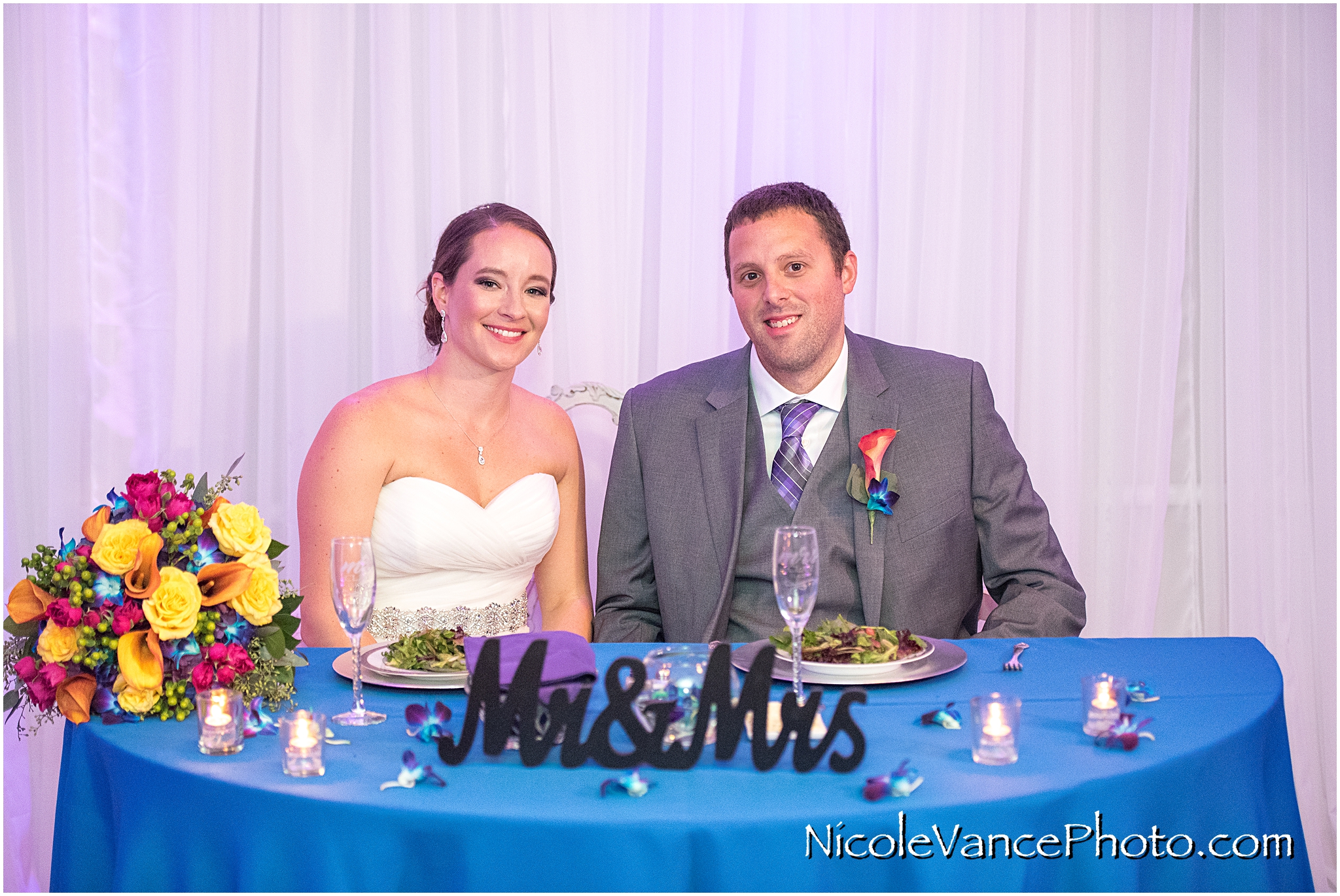 The bride and groom enjoy dinner at their wedding reception at The Brownstone with catering by Butler's Catering.