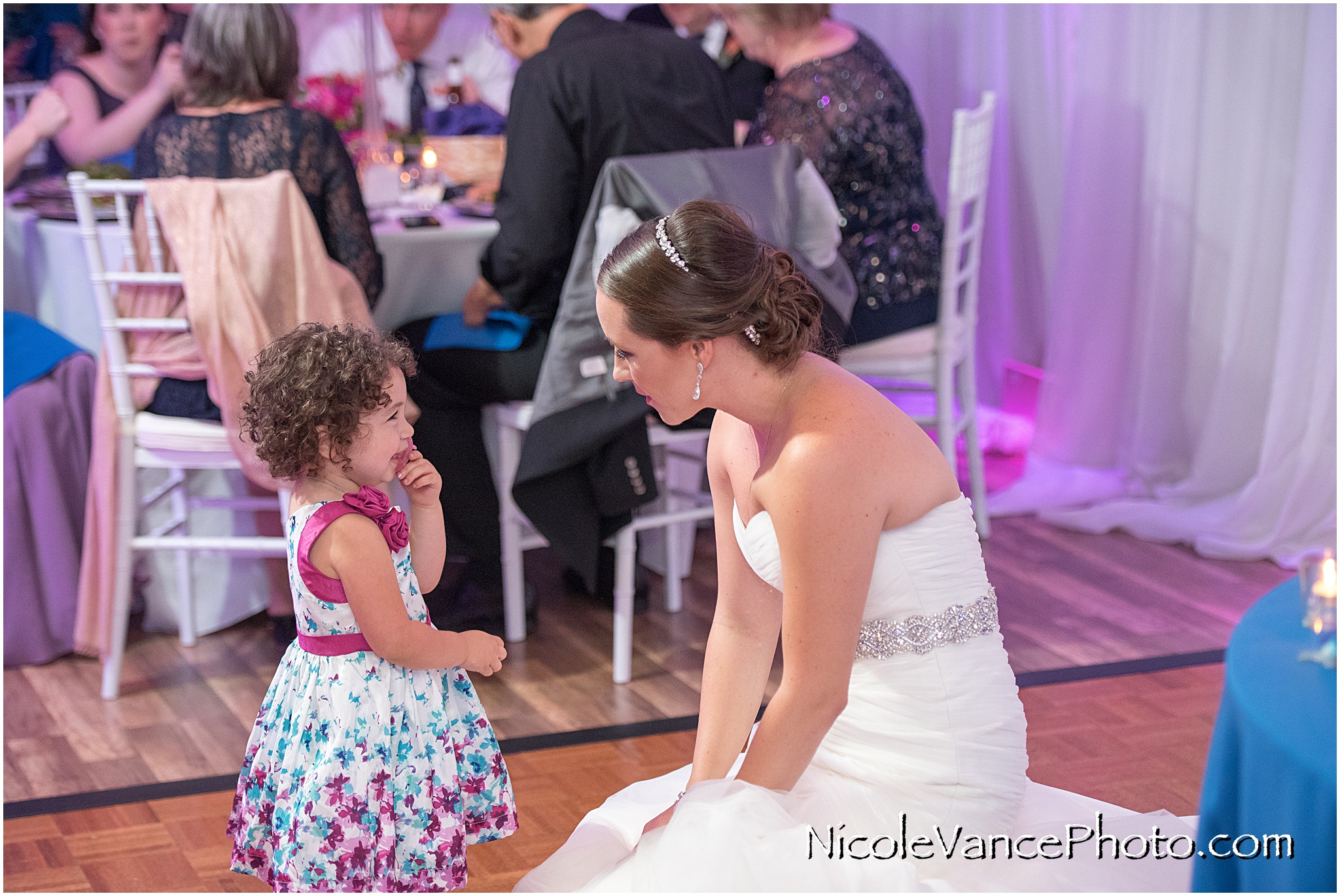 This is a cute moment between the bride and one of her youngest guests.