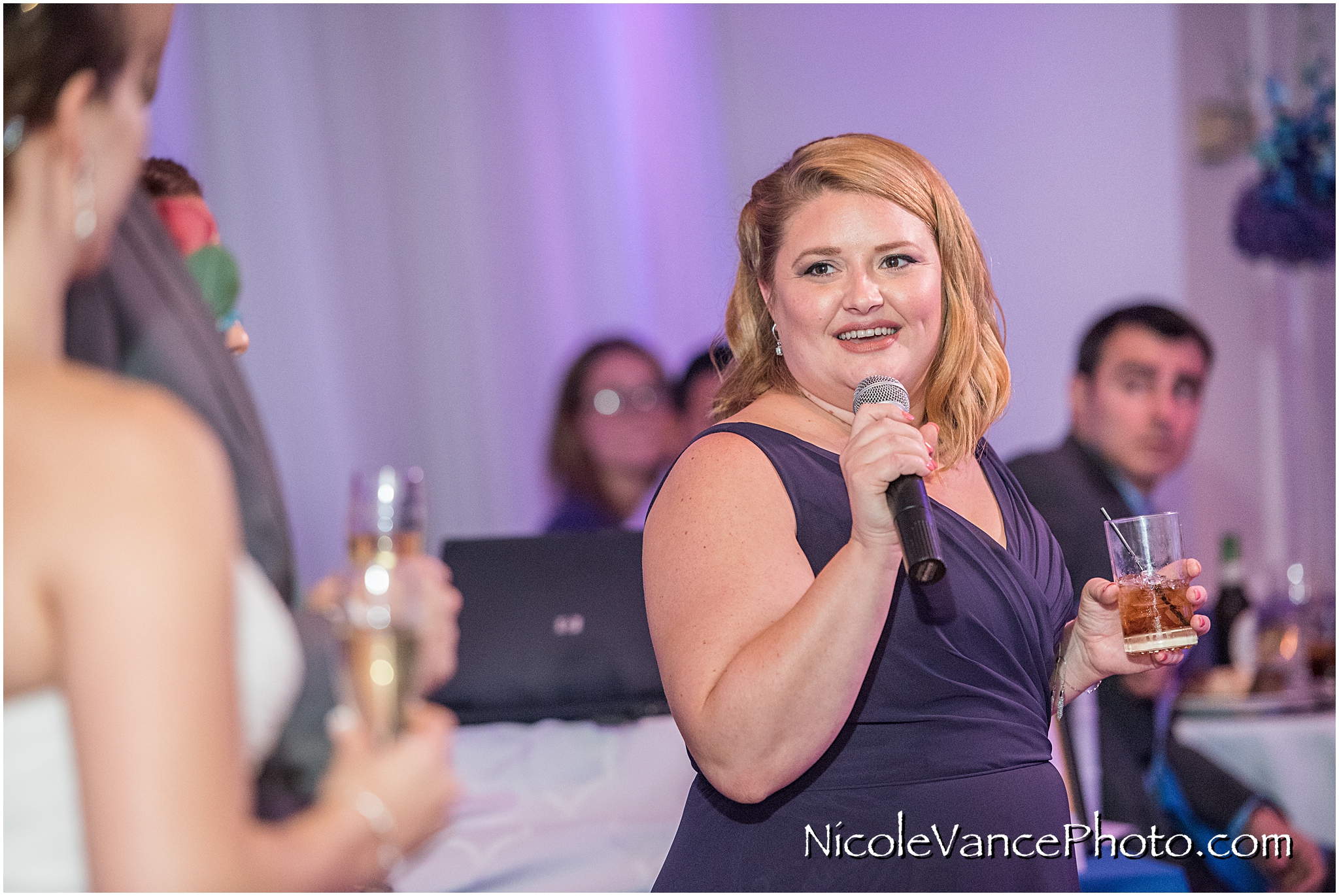 The maid of honor makes a toast to the bride and groom at The Brownstone in Richmond, VA.