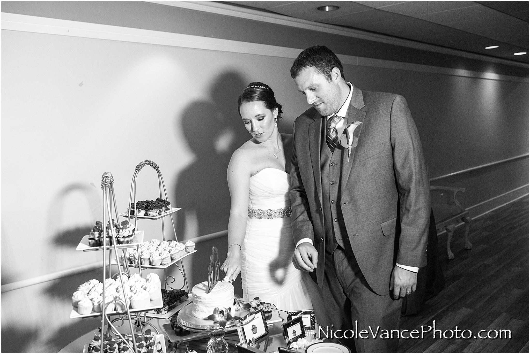 The bride and groom cut their cake, provided by Kakealicious at the reception at The Brownstone.