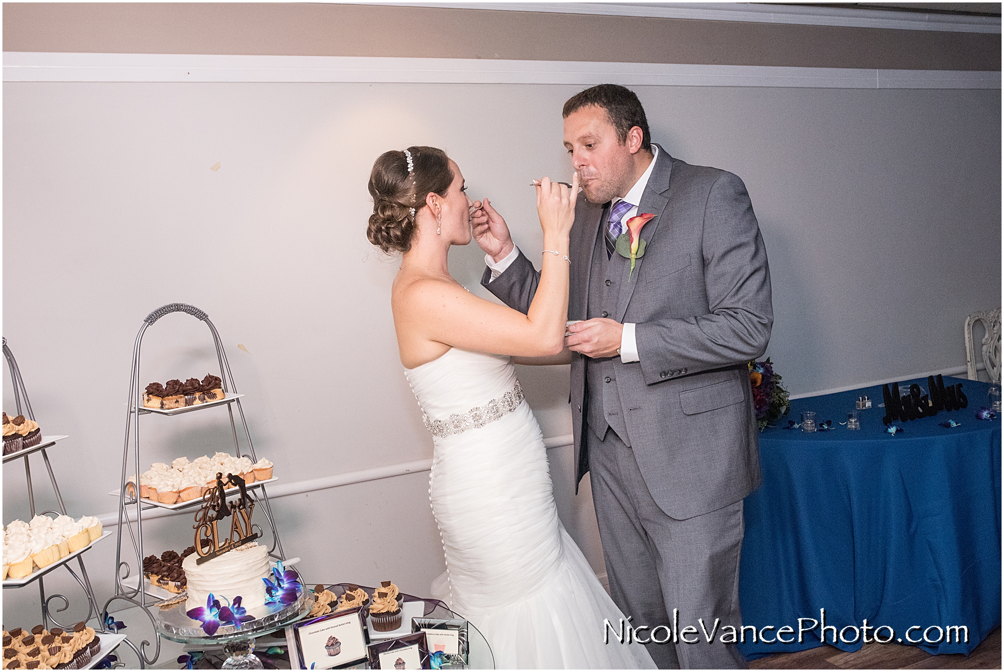 The bride and groom enjoy their cake, provided by Kakealicious at the reception at The Brownstone.