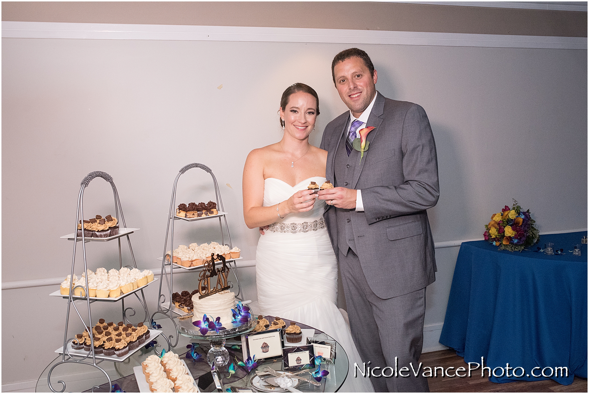 The bride and groom enjoy their cake, provided by Kakealicious at the reception at The Brownstone.