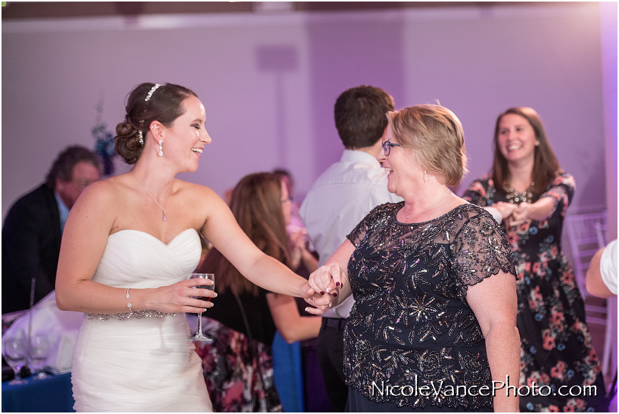 The bride and her mom enjoy the dance floor together.