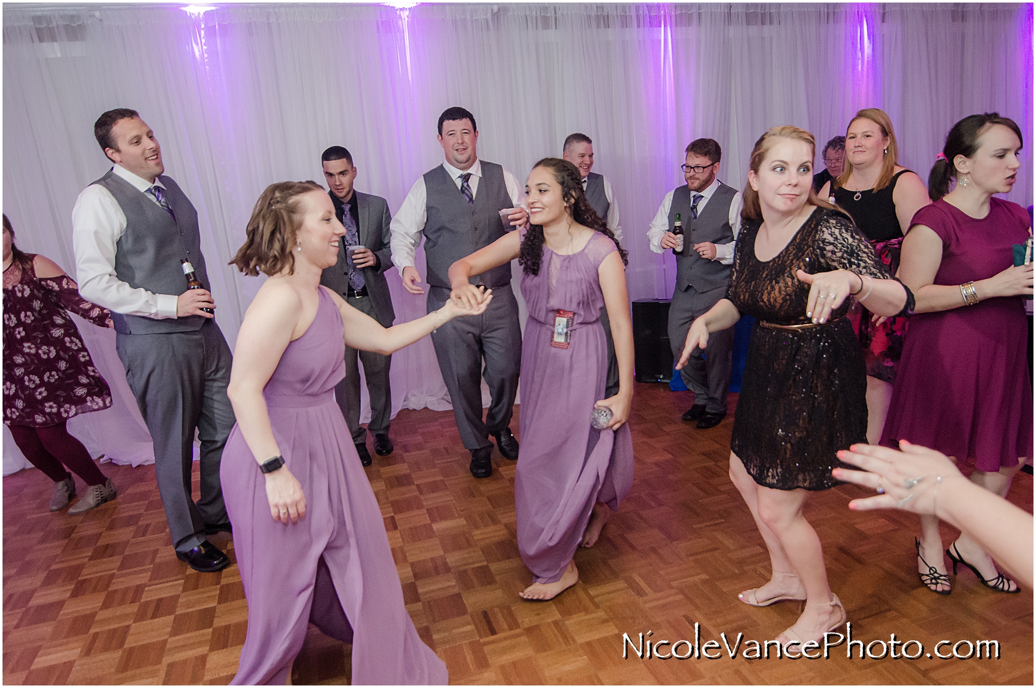 The guests enjoy music provided by DJ Patrick of Nard's DJ services at a reception at The Brownstone in Richmond Virginia.