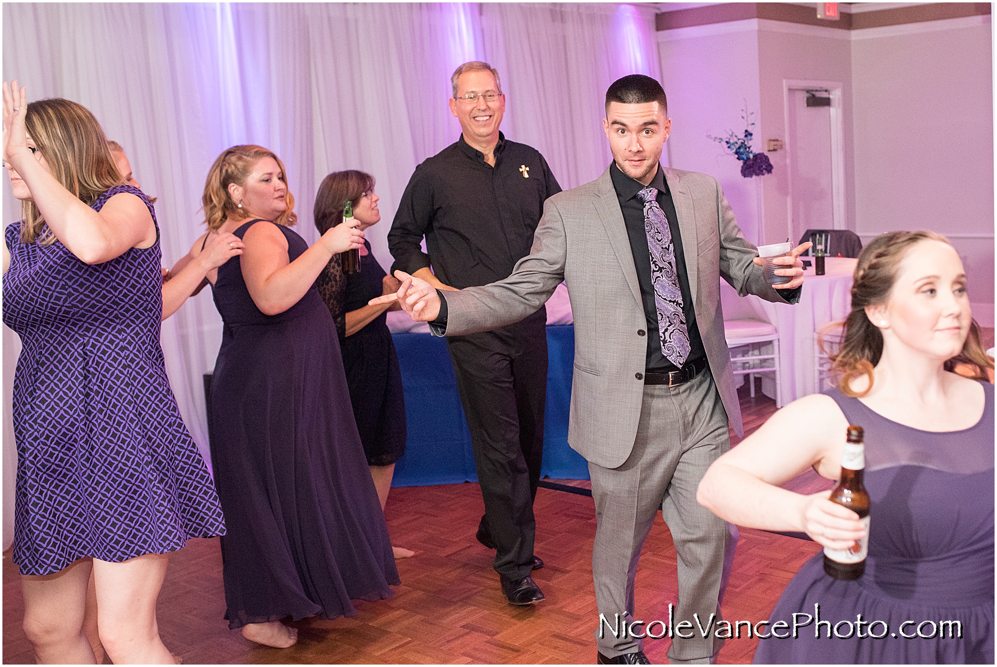 The guests enjoy music provided by DJ Patrick of Nard's DJ services at a reception at The Brownstone in Richmond Virginia.