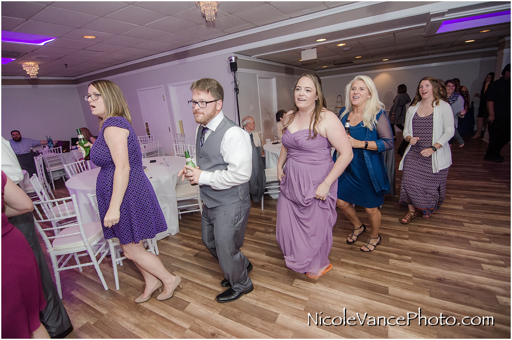 The guests enjoy music provided by DJ Patrick of Nard's DJ services at a reception at The Brownstone in Richmond Virginia.