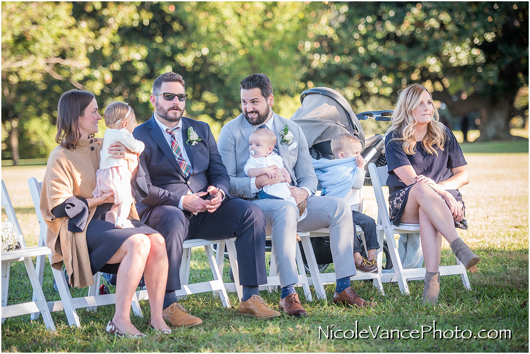 Guests enjoy the wedding ceremony with their young children at Maymont Park.