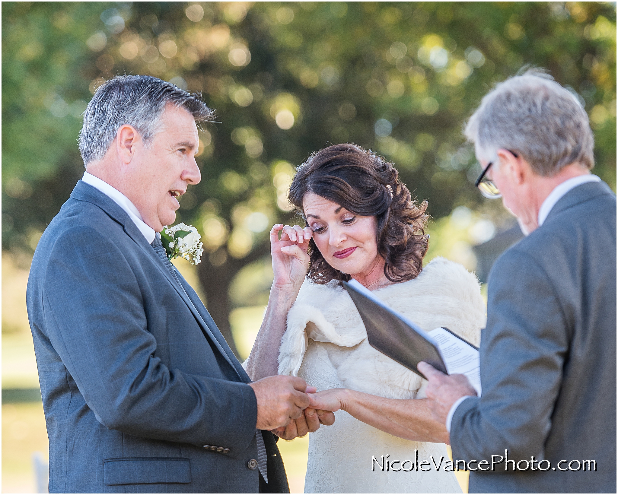 The couple exchange rings during their ceremony at Maymont Park.
