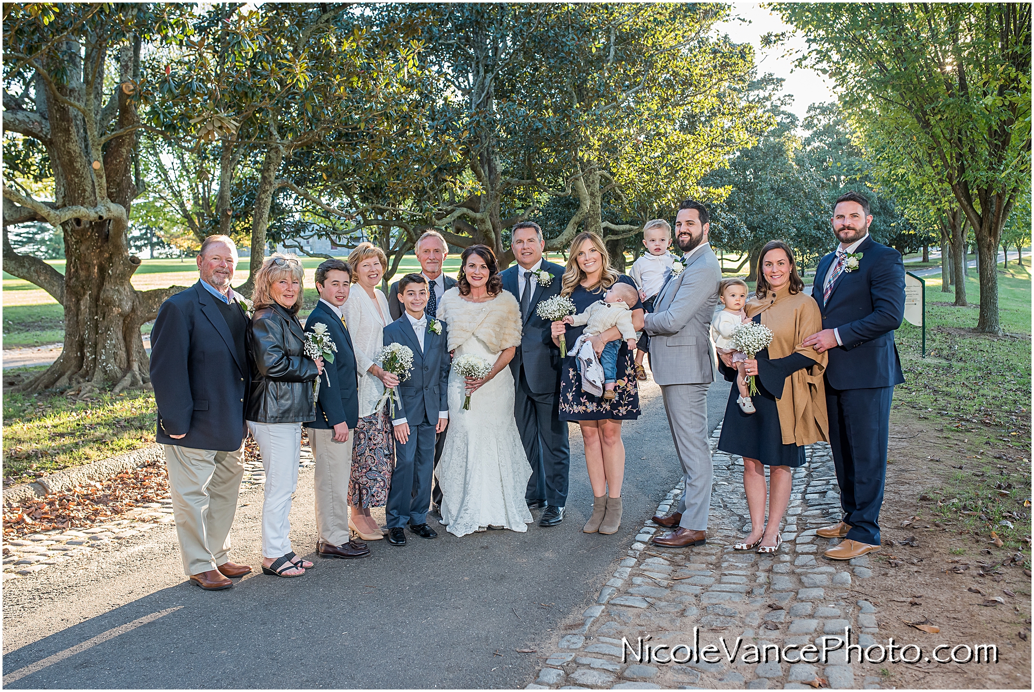 The bride and groom pose with all the guests in attendance at Maymont Park in Richmond, Virginia.